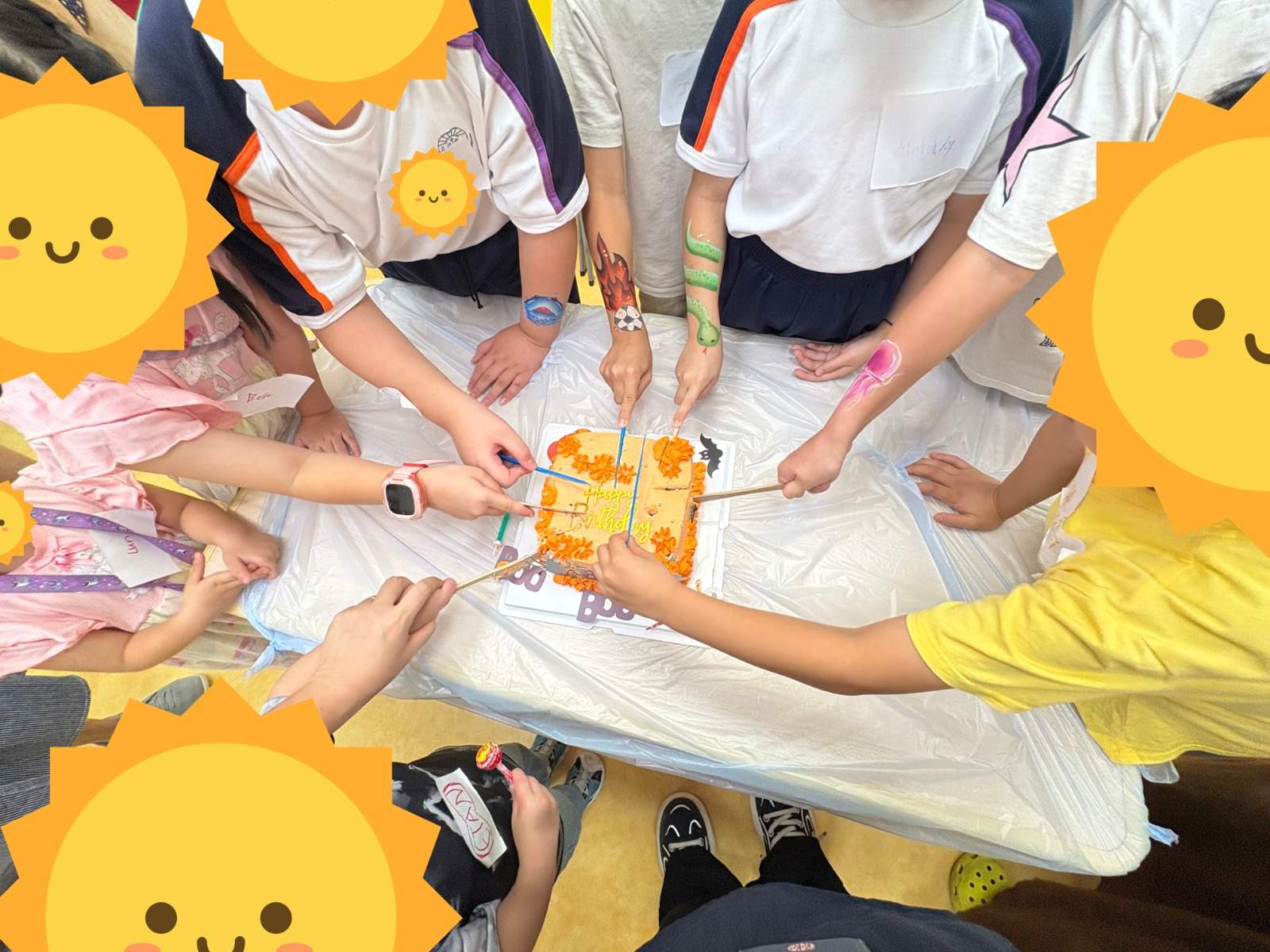 Children reaching together to cut a birthday cake on a table.