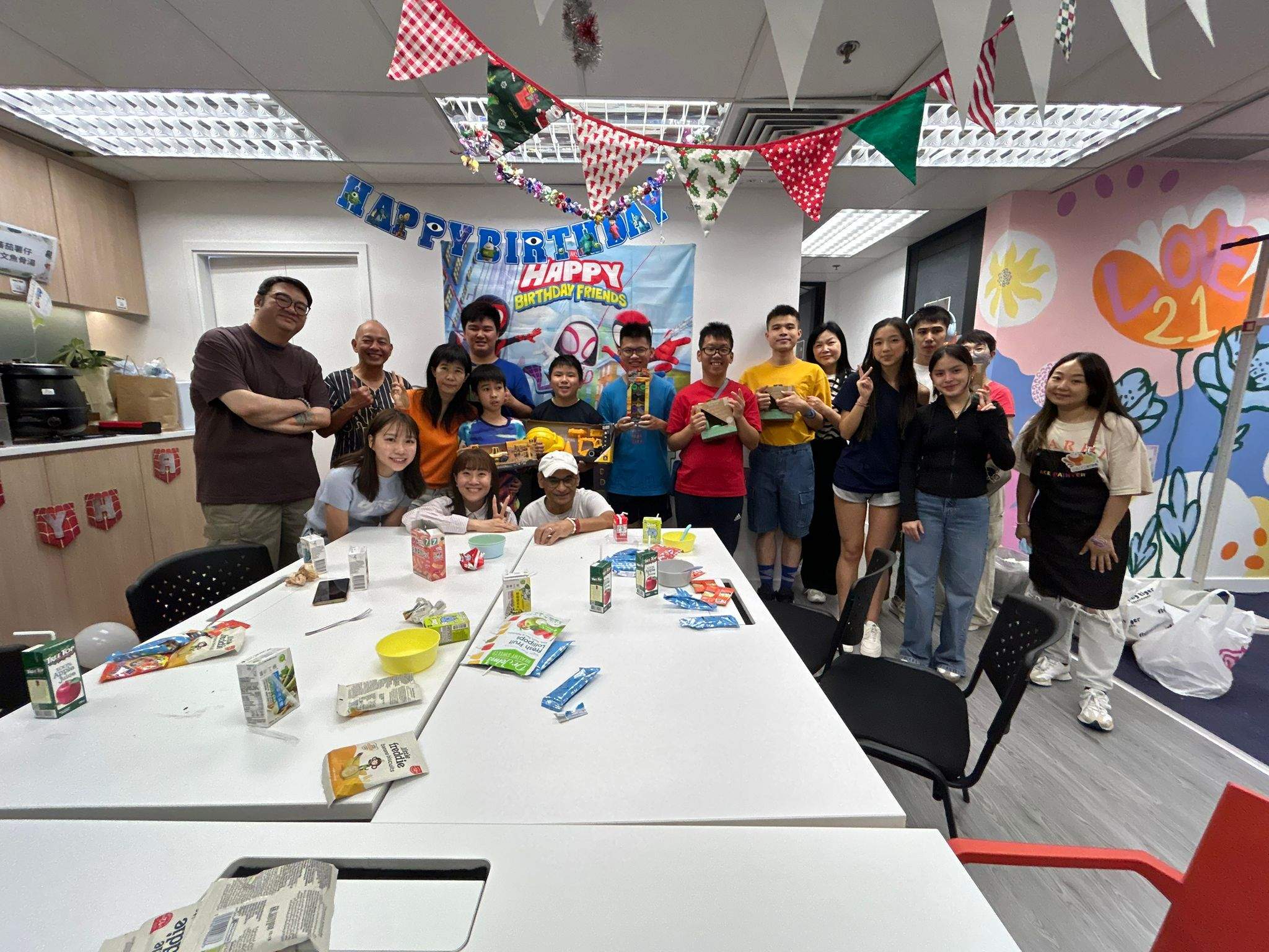 A large group poses together around a long table.