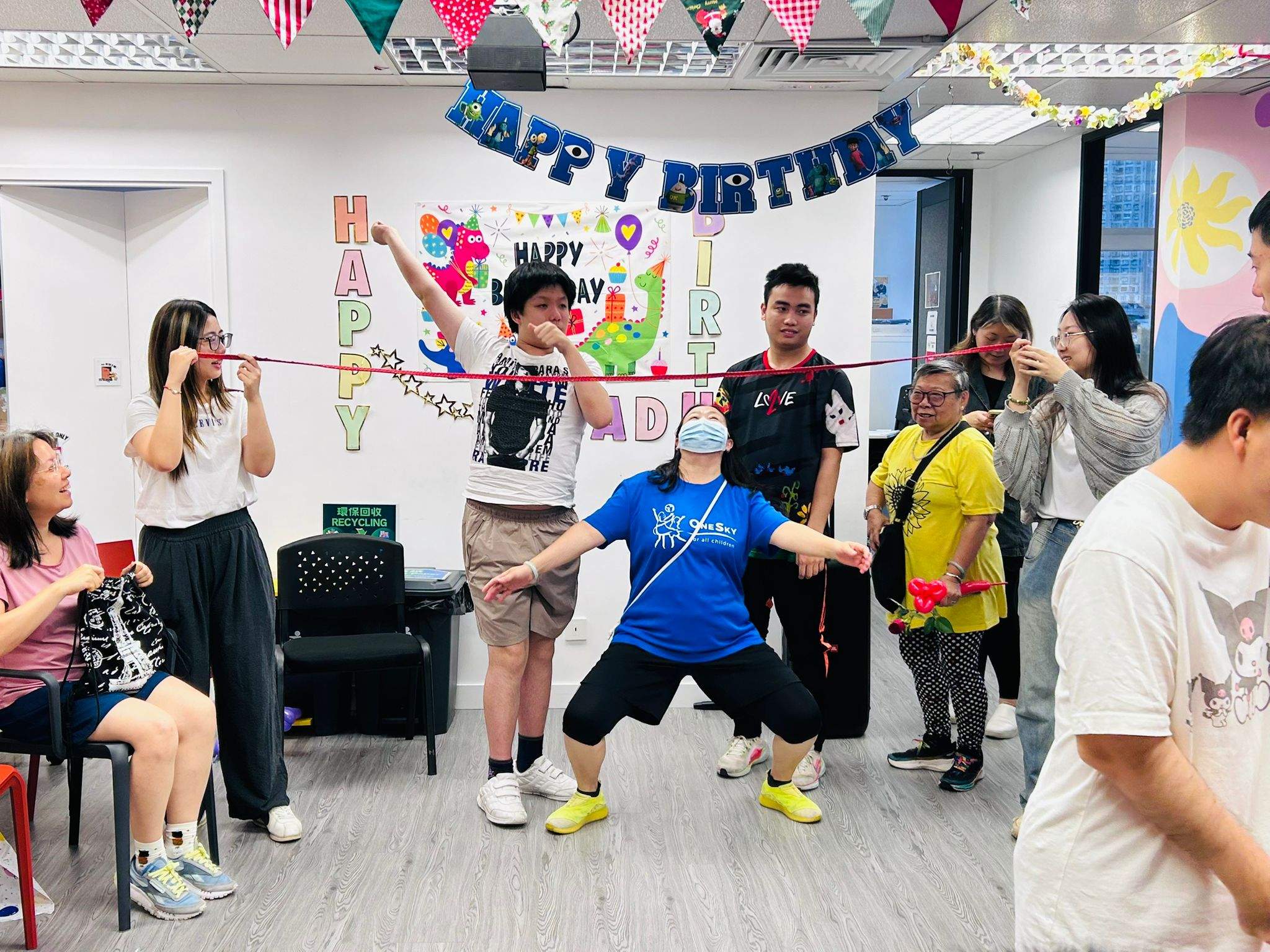 A performer leads several adults through an activity before the group.