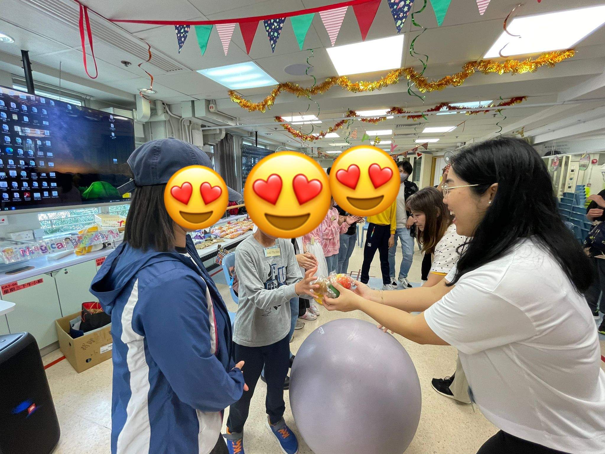 An adult leads a balloon activity with several participants.