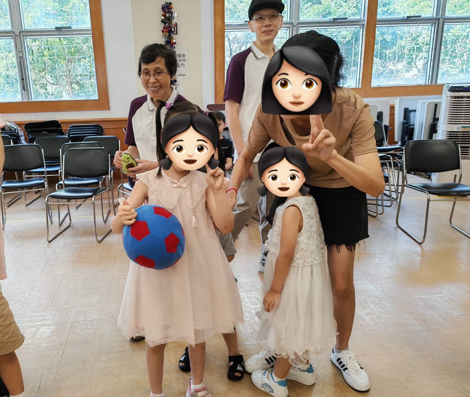 Two children stand with adults and an armored character indoors.