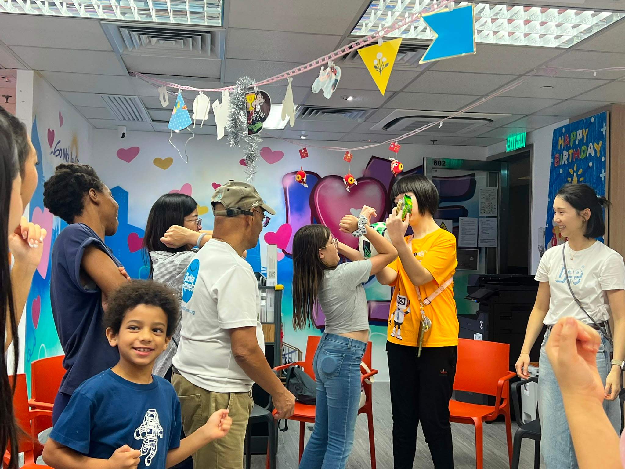 People raise their hands together during an indoor game.