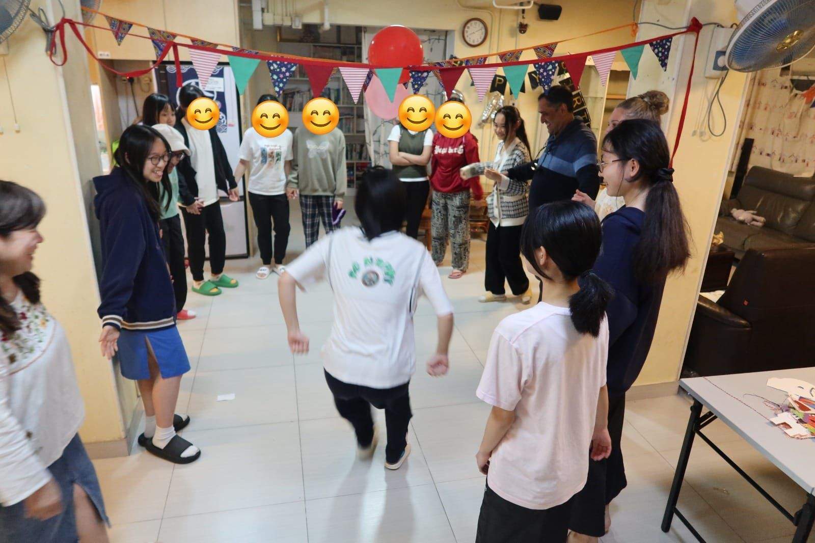 Children move through the room during an active group game.