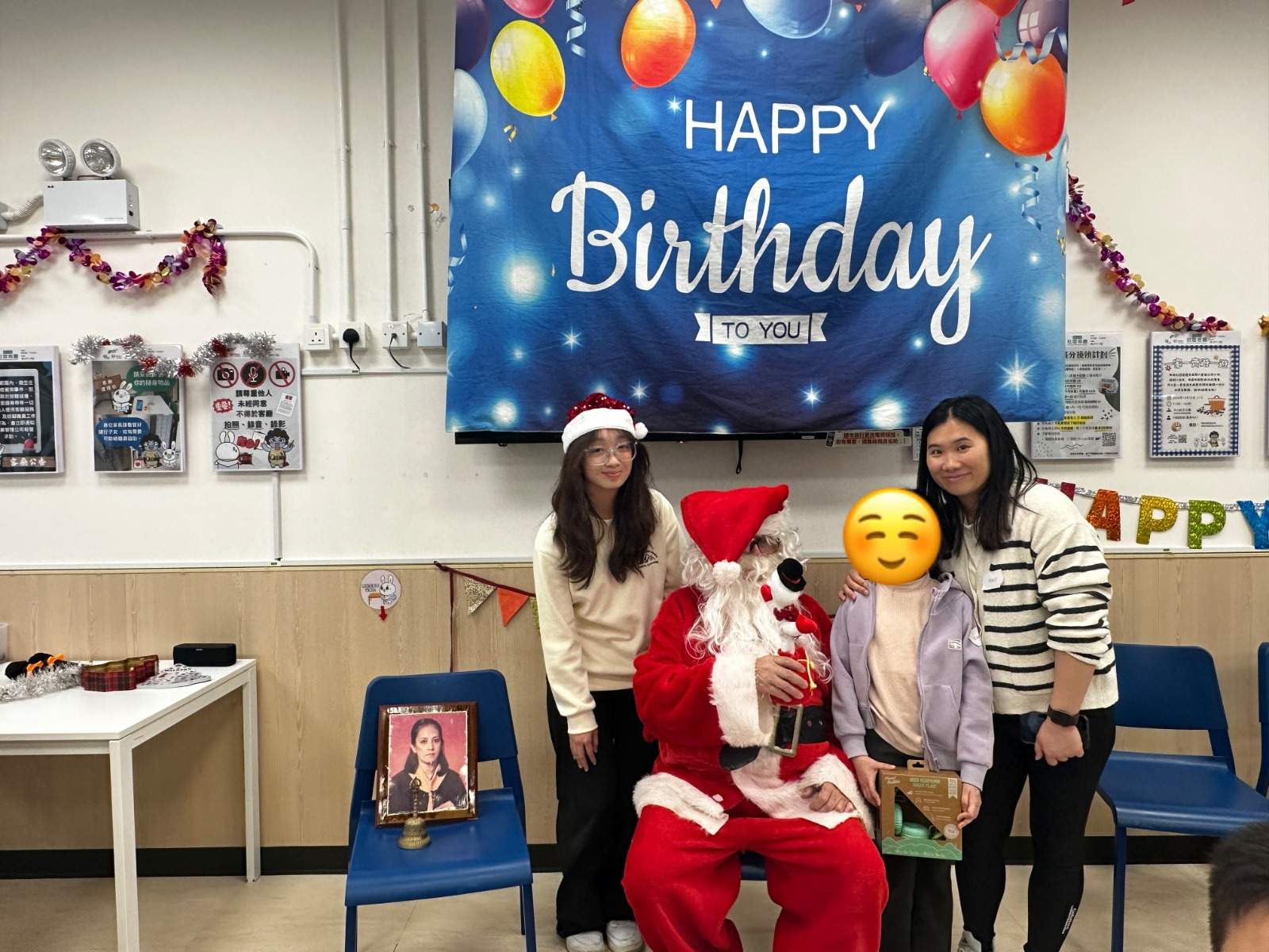 Two adults stand beside a costumed adult and child.