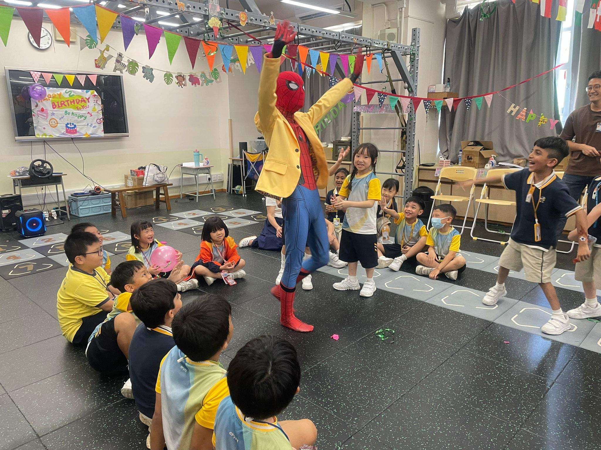 A costumed performer leads children seated in a semicircle.