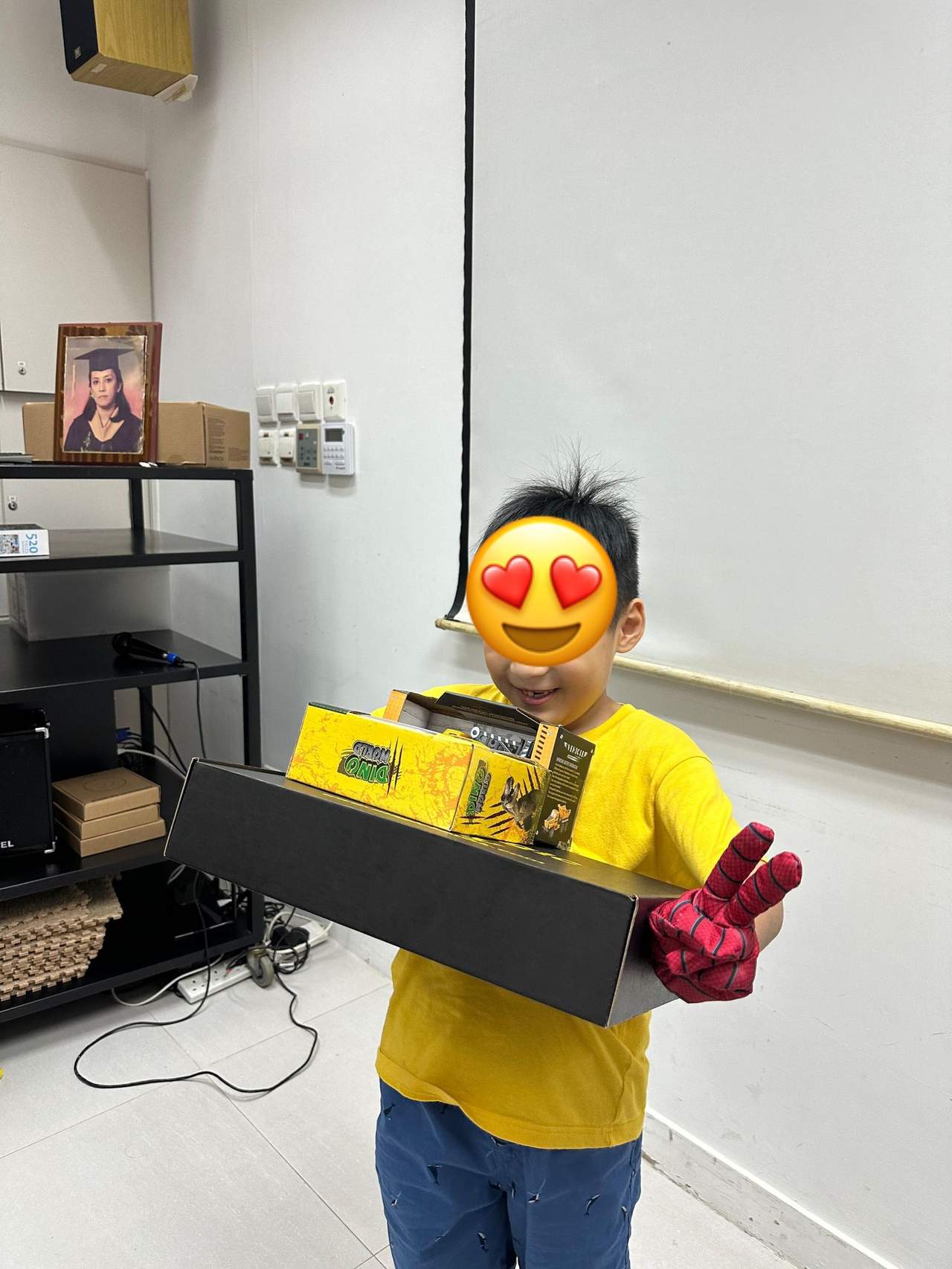 A child holds a long boxed gift for the camera.