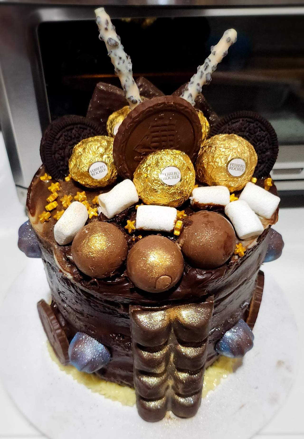 A chocolate celebration cake loaded with Ferrero Rocher, cookies and marshmallows, by Mabel Chan.