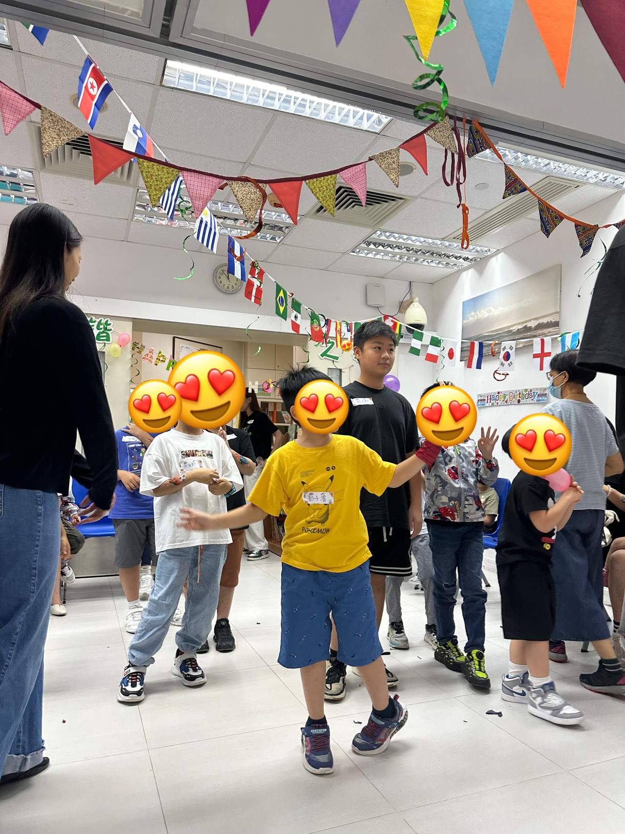 Children walk in a line during an indoor game.