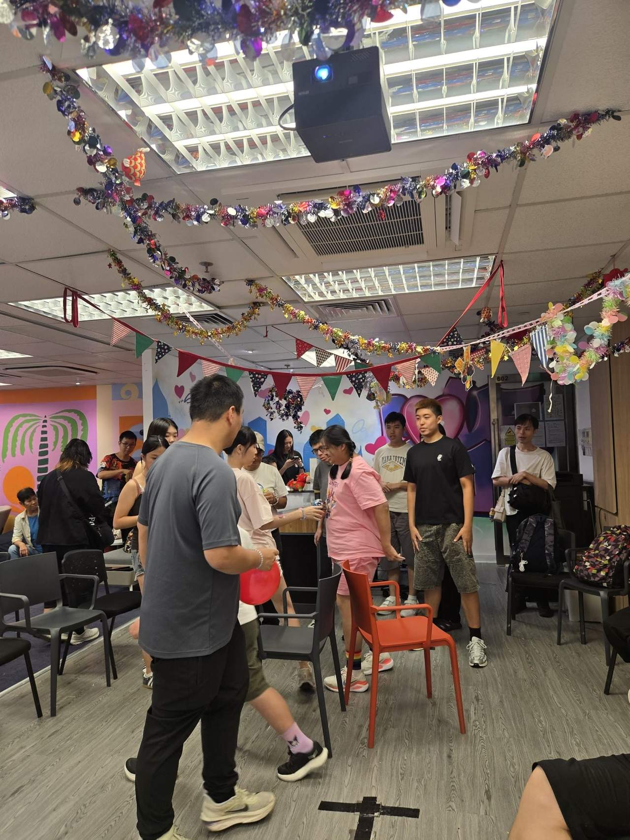 A volunteer leads participants through an indoor group game.