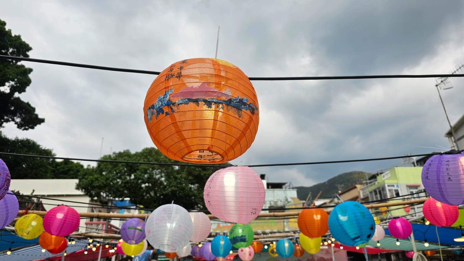 Colorful lanterns hang above a Tai O street after the party.