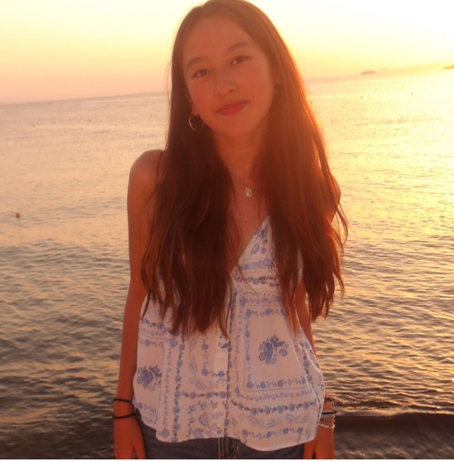 Gwen Farnen, team leader, by the sea at sunset.