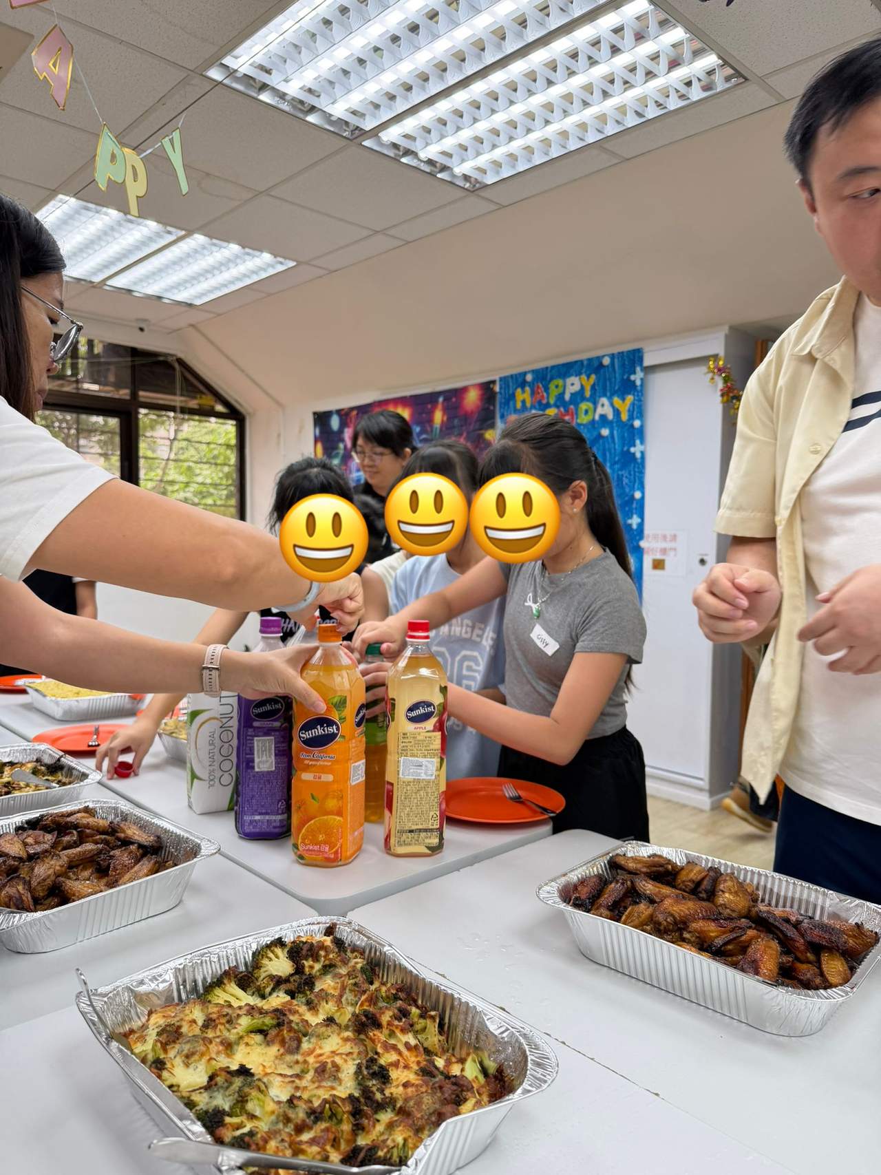 Participants serve drinks and food from a buffet table.