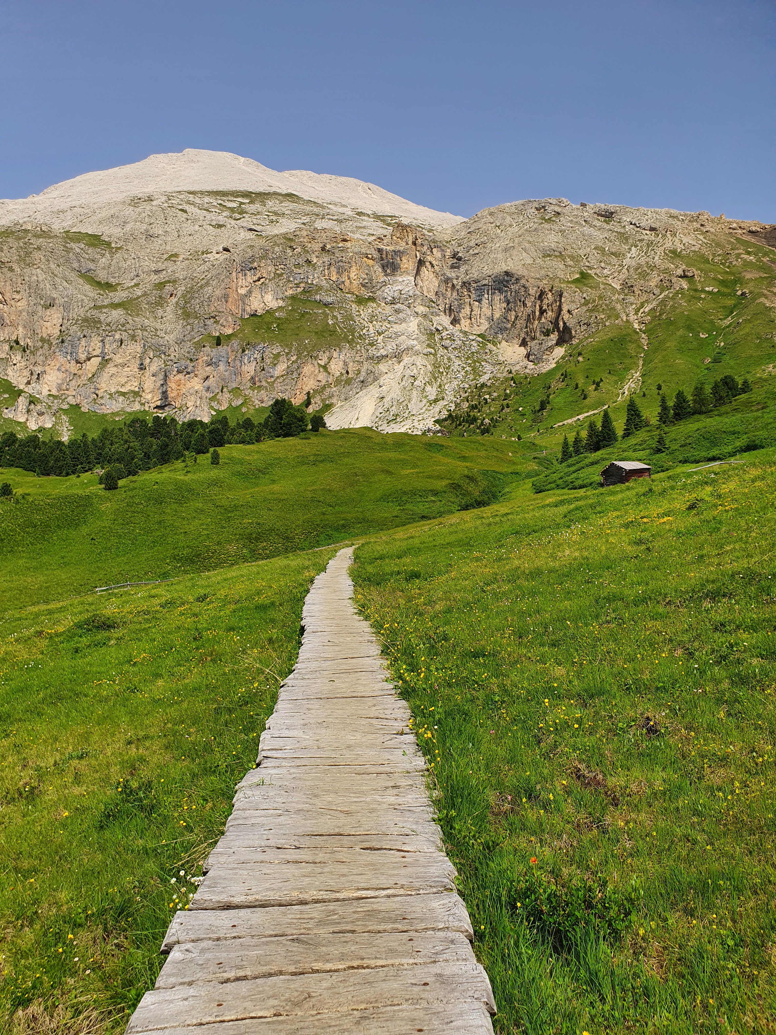 Ancient streets church with Dolomites in the background
