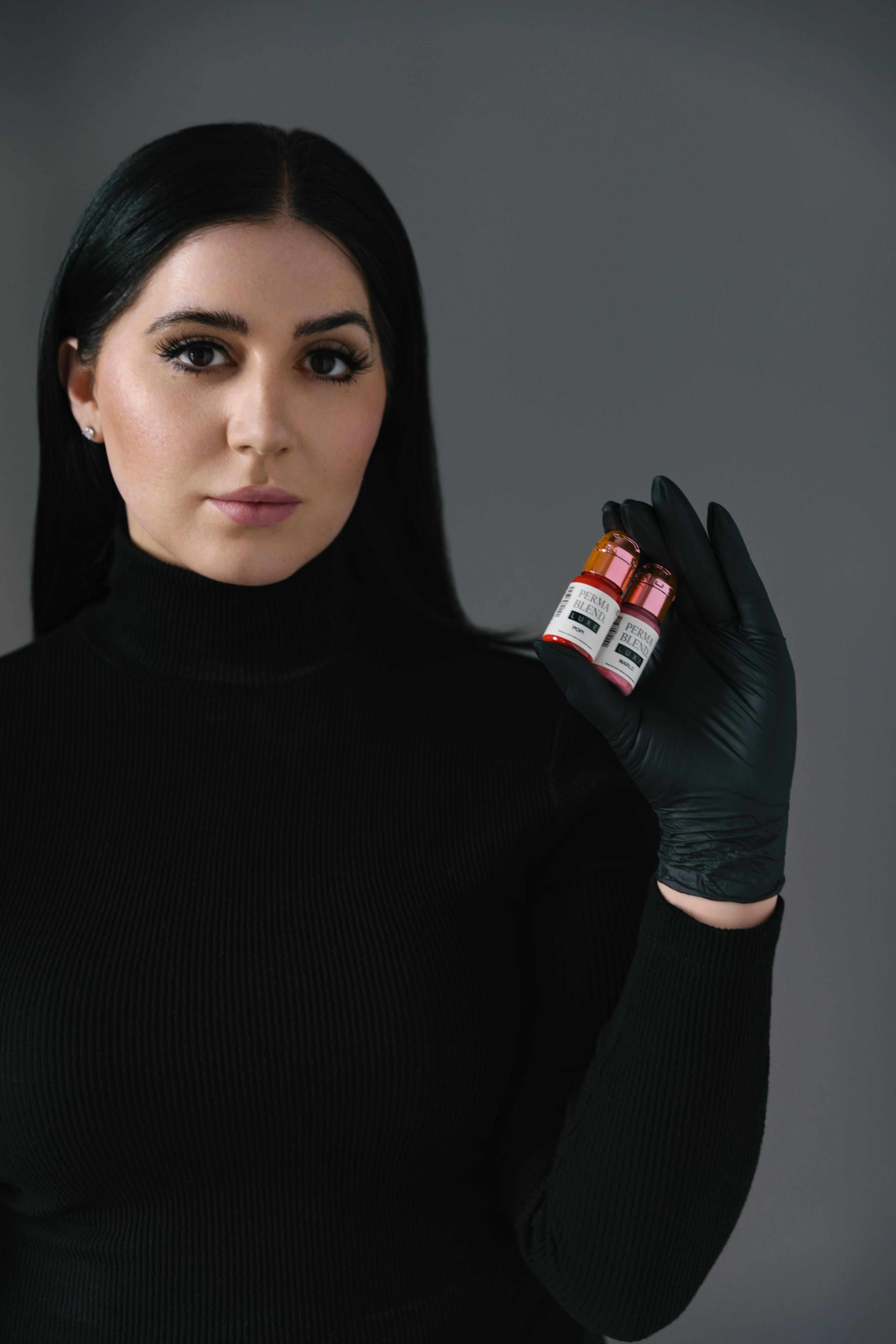 Meredith holding two Hanafy pigments in professional portrait photoshoot
