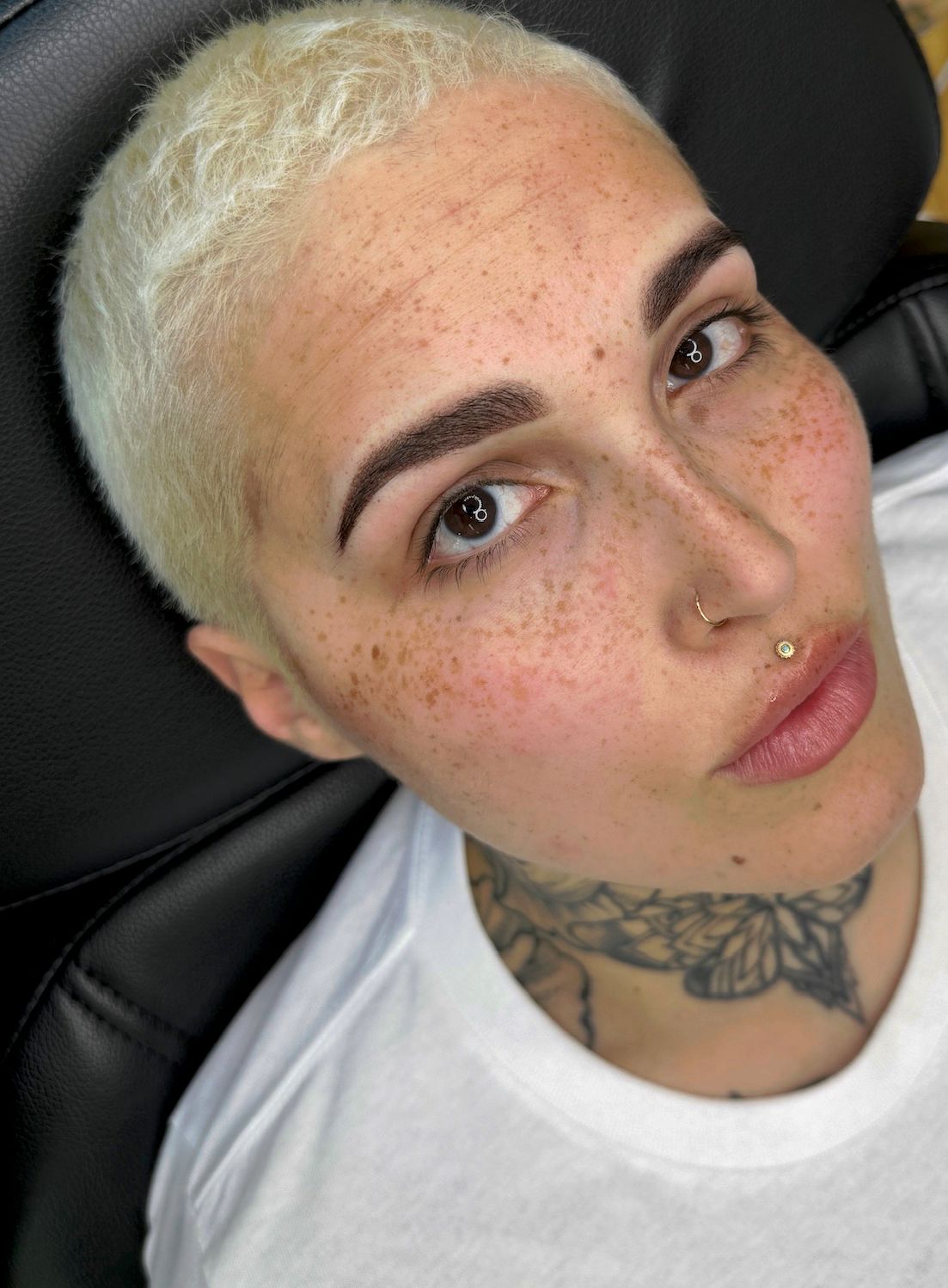 Powder brow shading done at MOKO Beauty in Stoneham on client with short blonde hair and lip piercing.