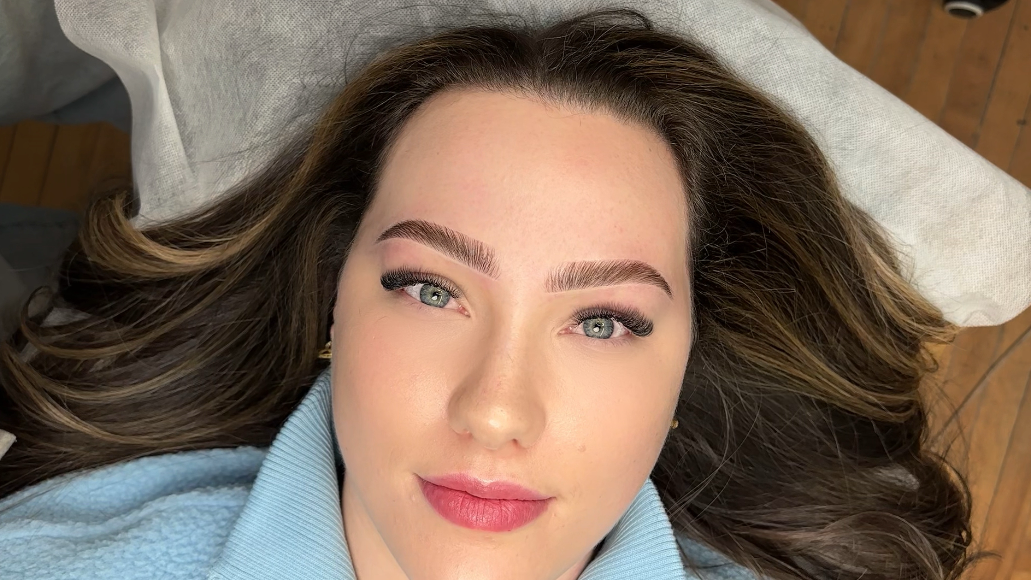 Freshly done brow lamination on a woman with green eyes at MOKO Beauty