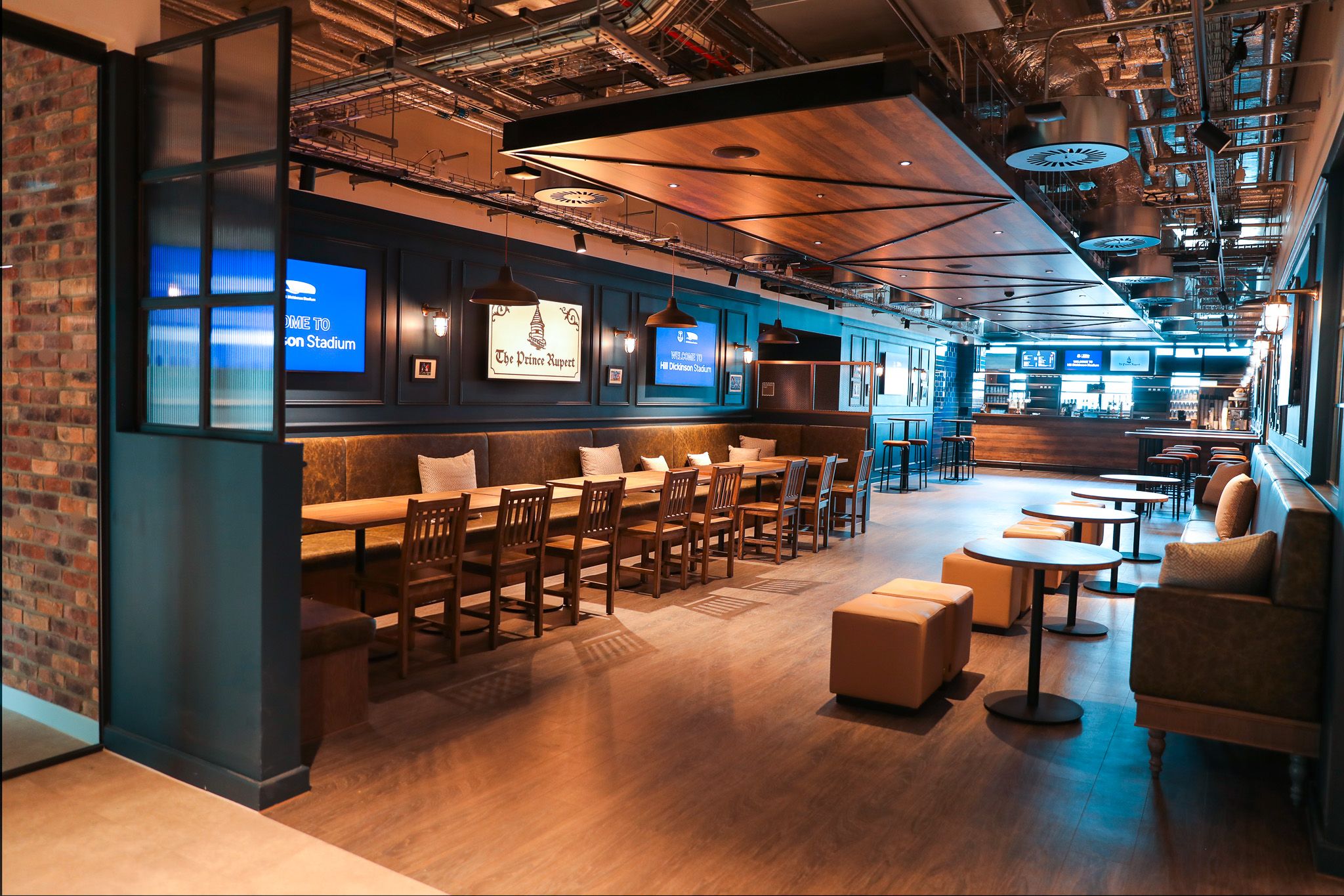 Village Street, Hill Dickinson Stadium: The Prince Rupert pub interior, wide angle with brick partition and lounge seating