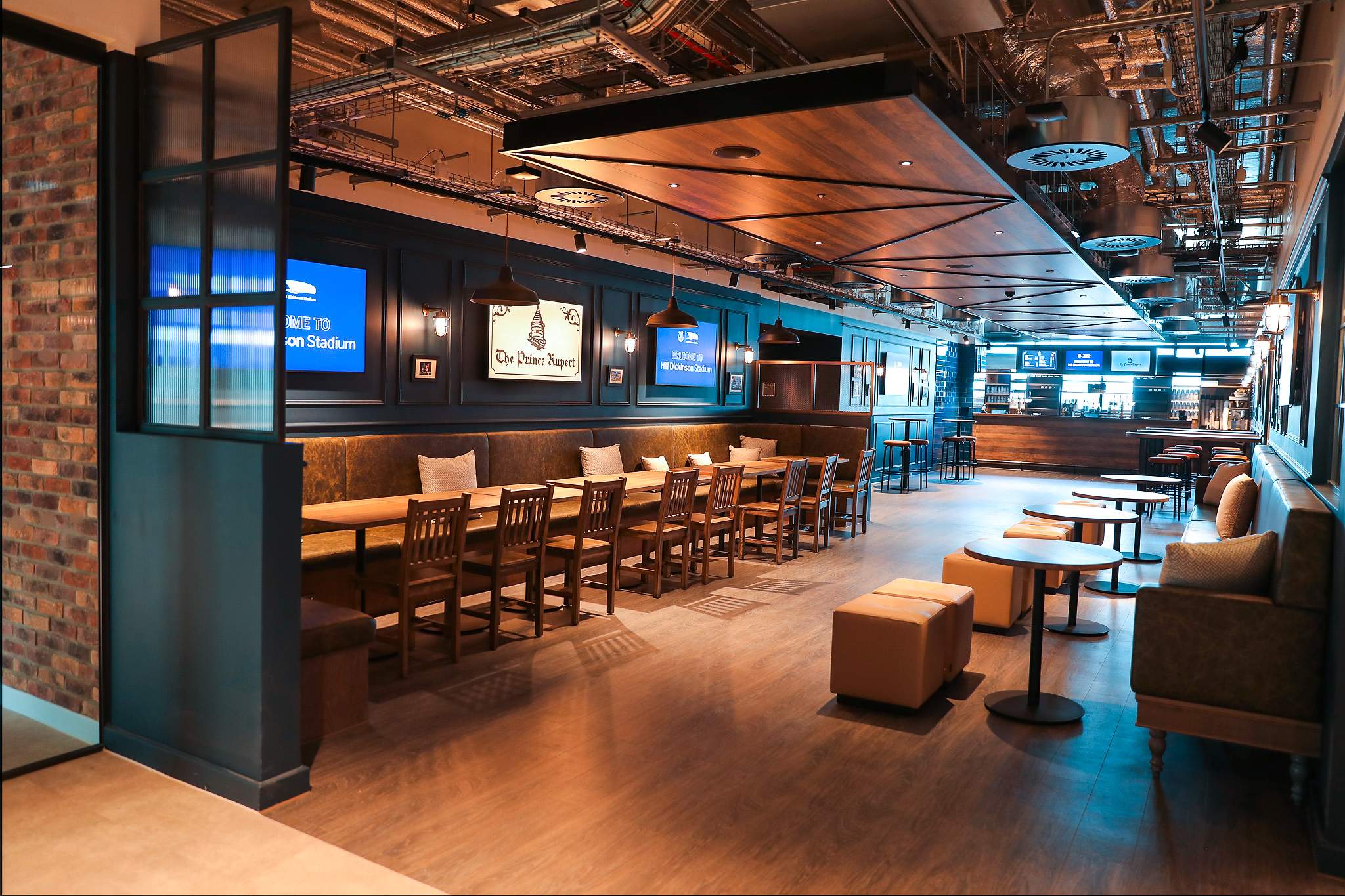 Village Street, Hill Dickinson Stadium: The Prince Rupert pub interior, wide angle with brick partition and lounge seating