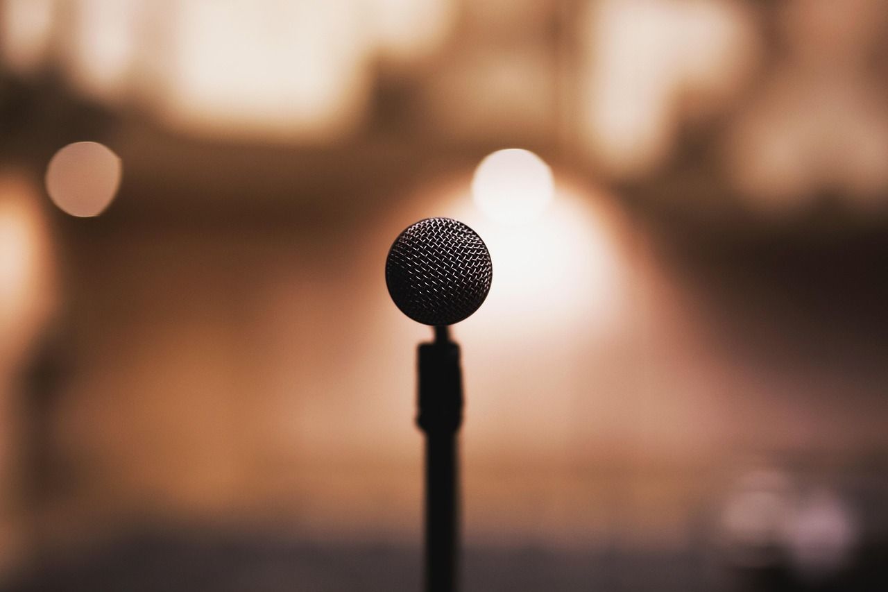 Microphone on stage under warm spotlight