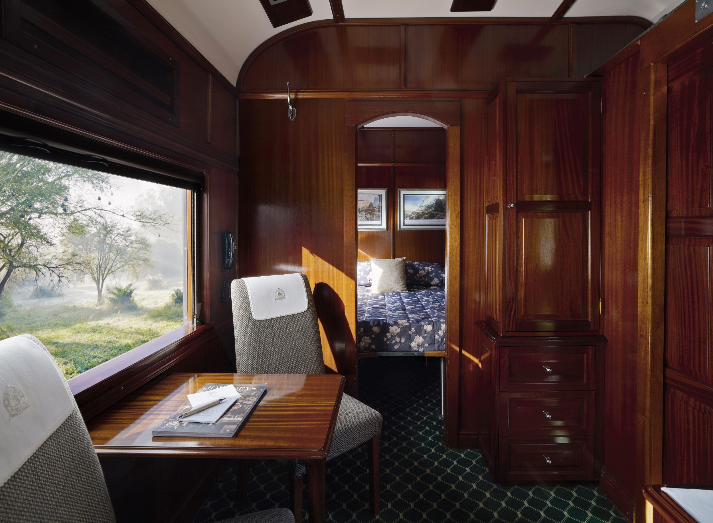 Interior of a Rovos Rail Deluxe Suite showing wood-panelled walls and period furnishings