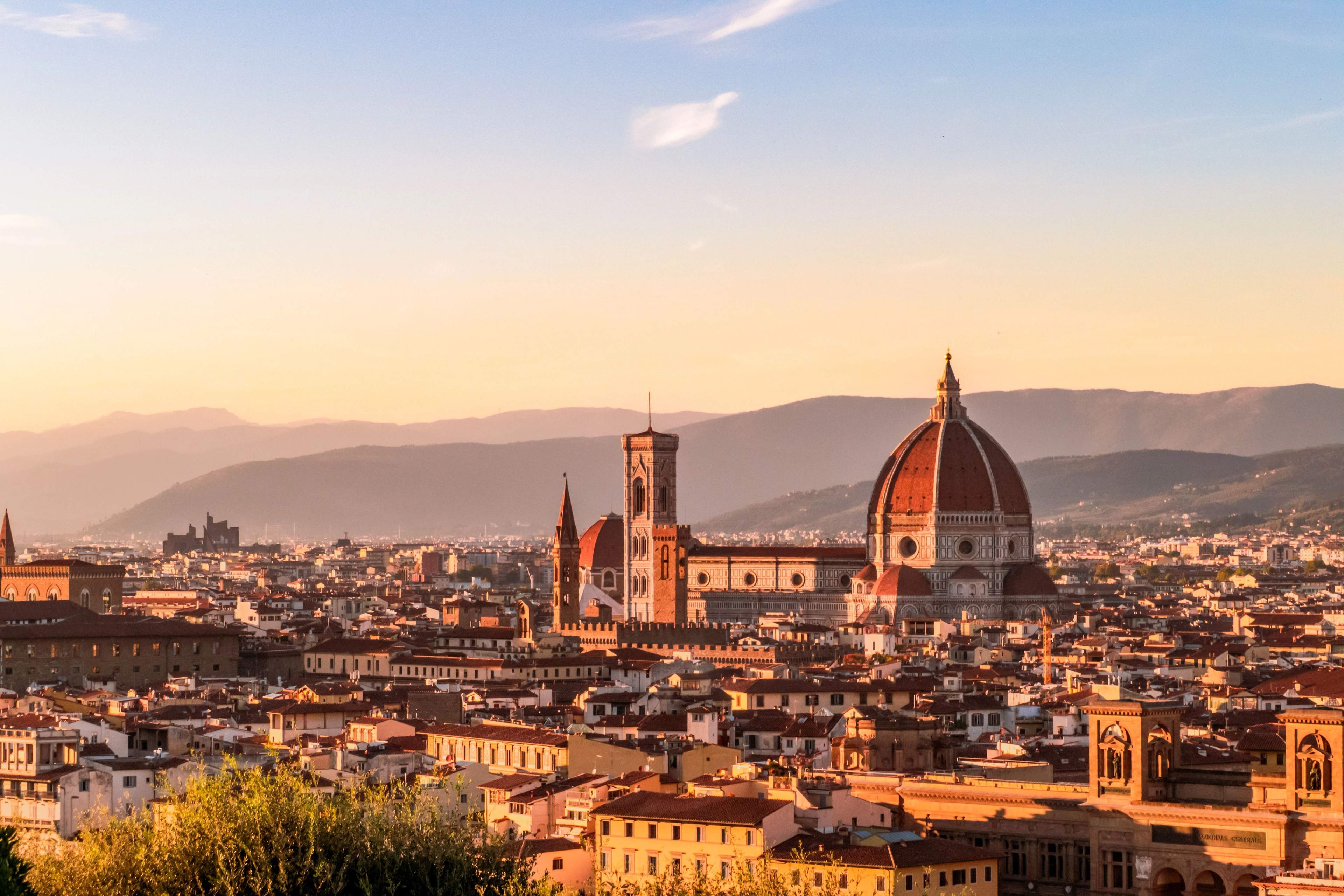 Florence at sunset, with the Duomo and Giotto's bell tower rising above the rooftops