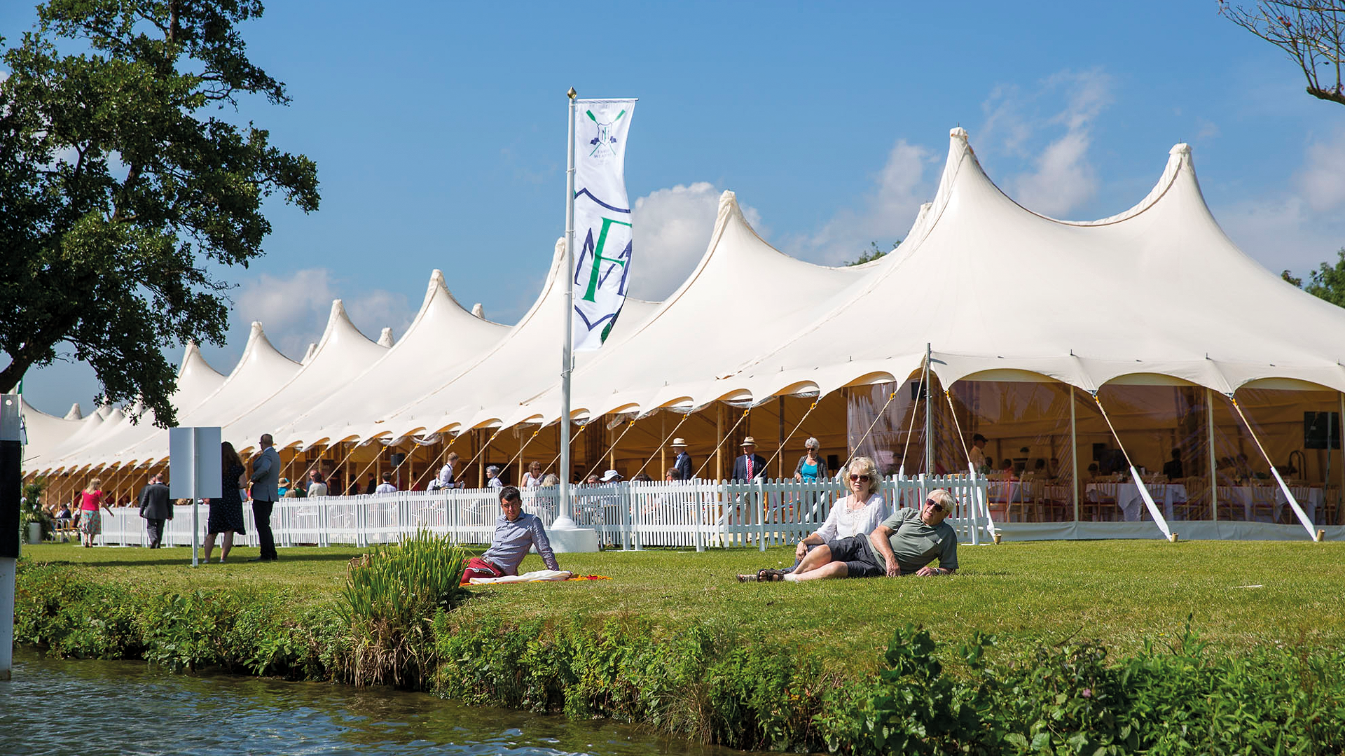 The blue and white striped enclosure marquees lining the bank at Henley Royal Regatta
