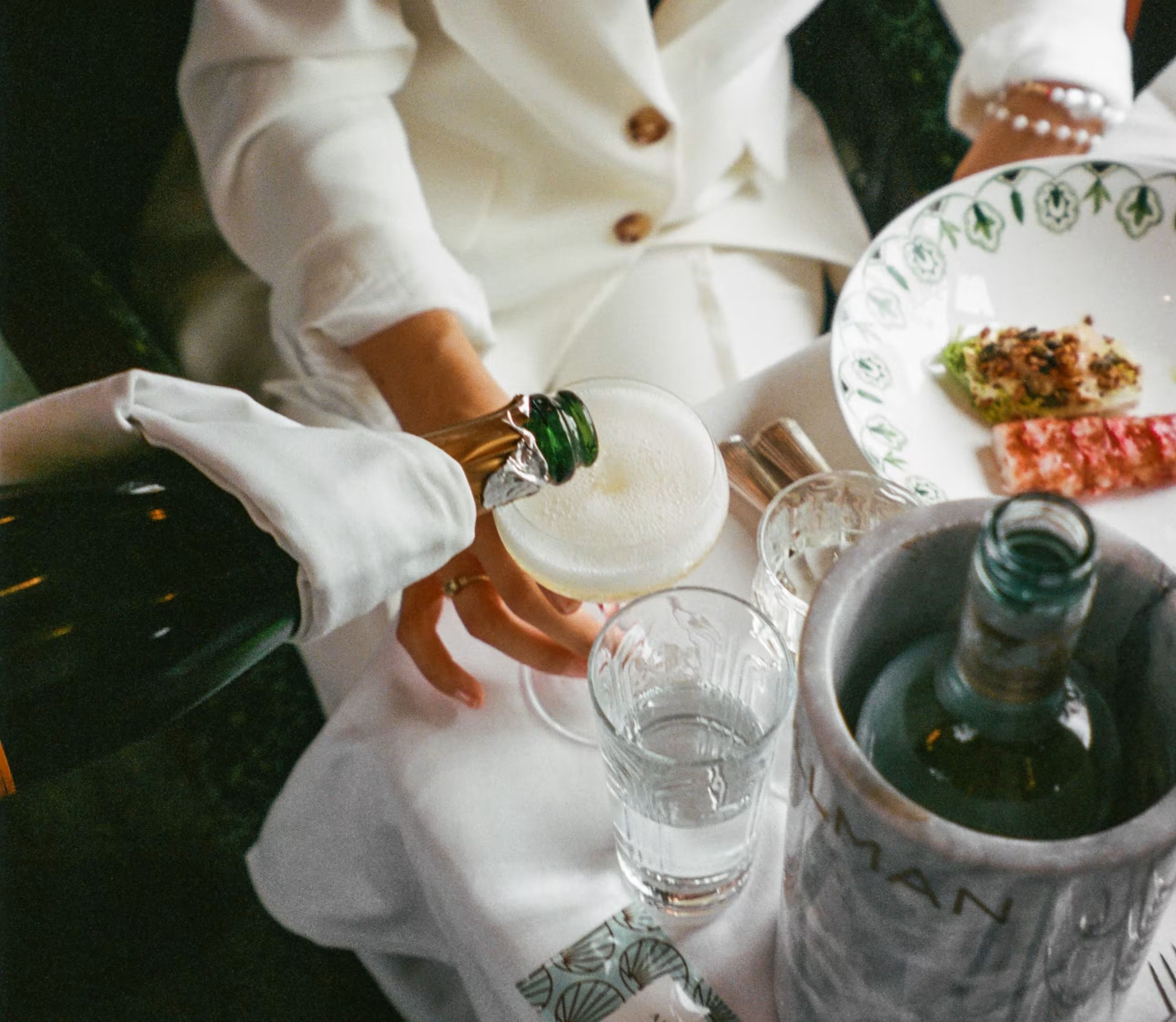 The interior of the Belmond British Pullman dining carriage with white linen tables
