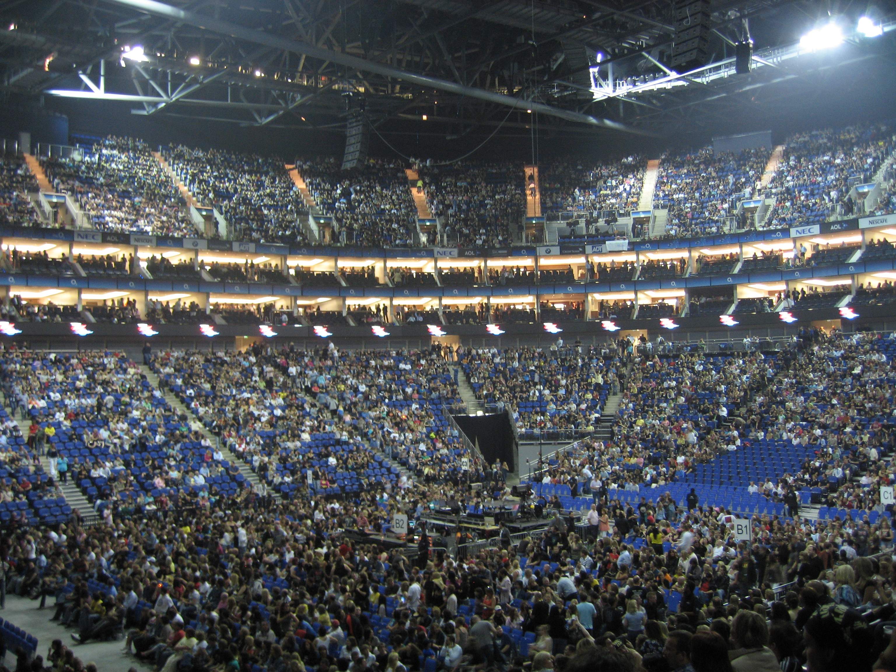 The flat arena floor and rising seating tiers at The O2 during a concert in 2007