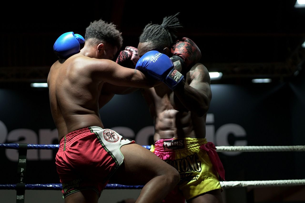 Two heavyweight boxers exchanging blows during a professional bout