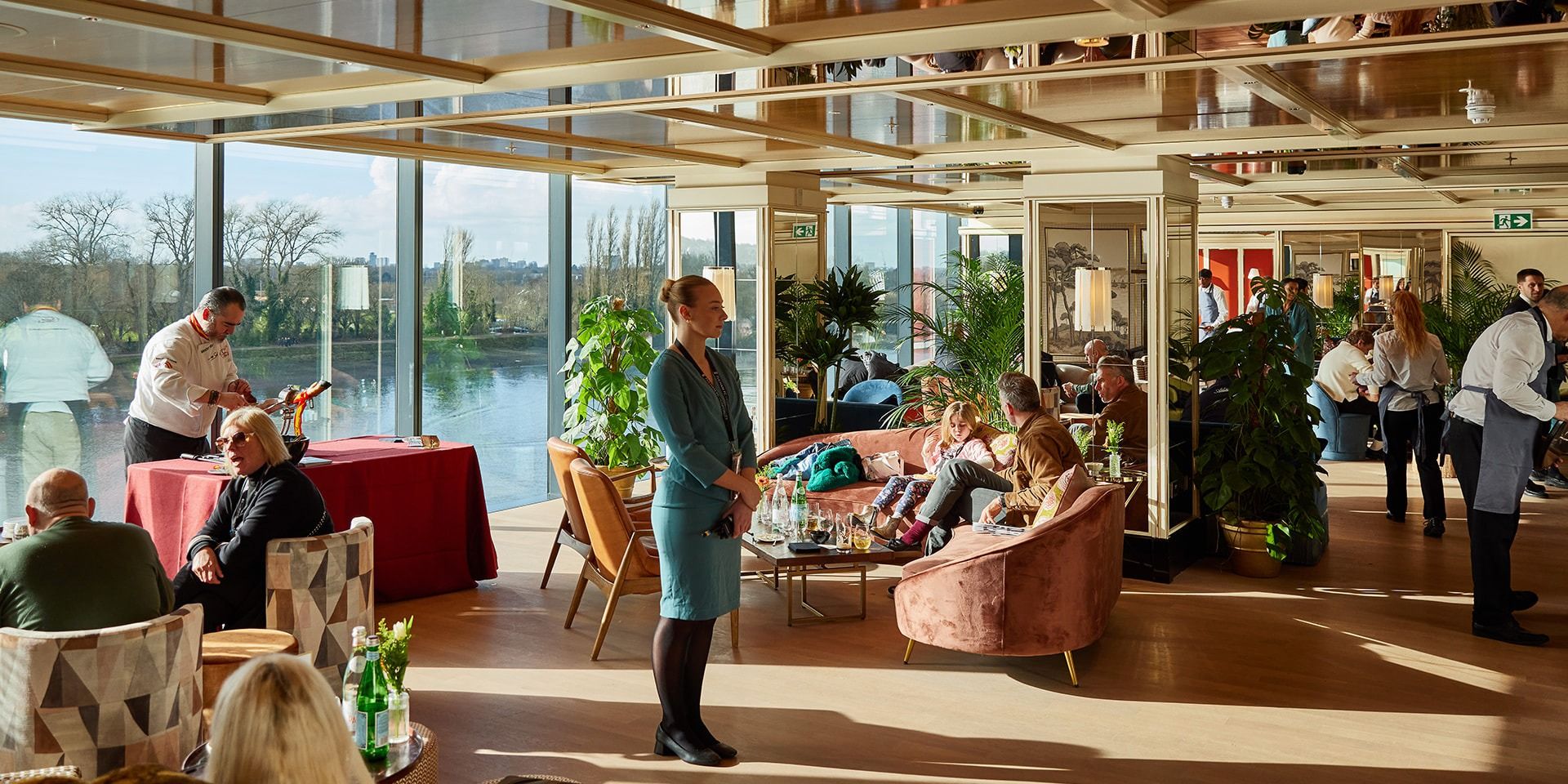 Sunlit Sky Deck lounge with floor-to-ceiling windows overlooking the River Thames