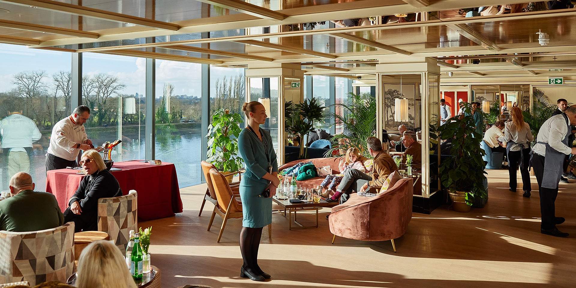 Sunlit Sky Deck lounge with floor-to-ceiling windows overlooking the River Thames