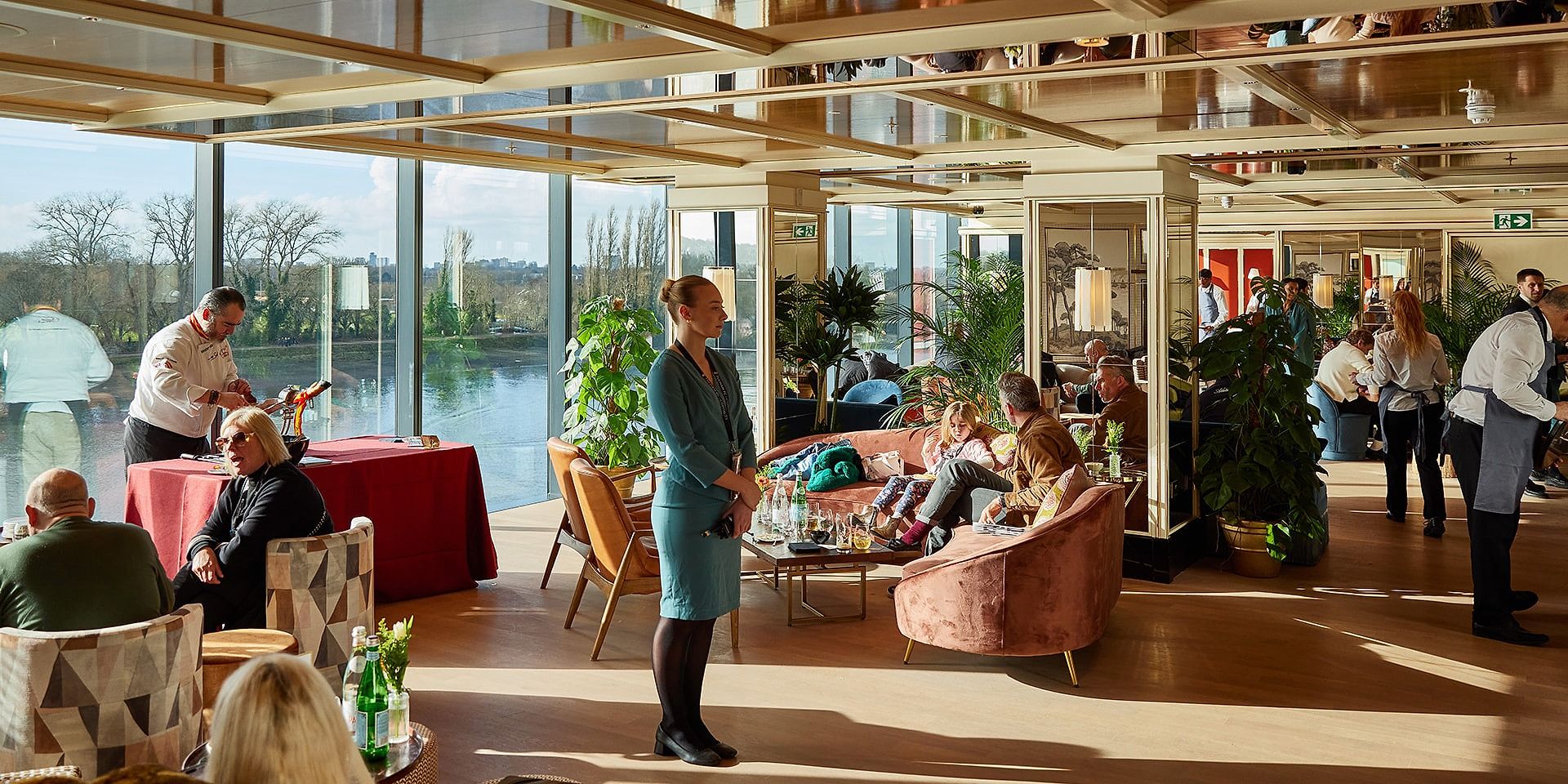 Sunlit Sky Deck lounge with floor-to-ceiling windows overlooking the River Thames
