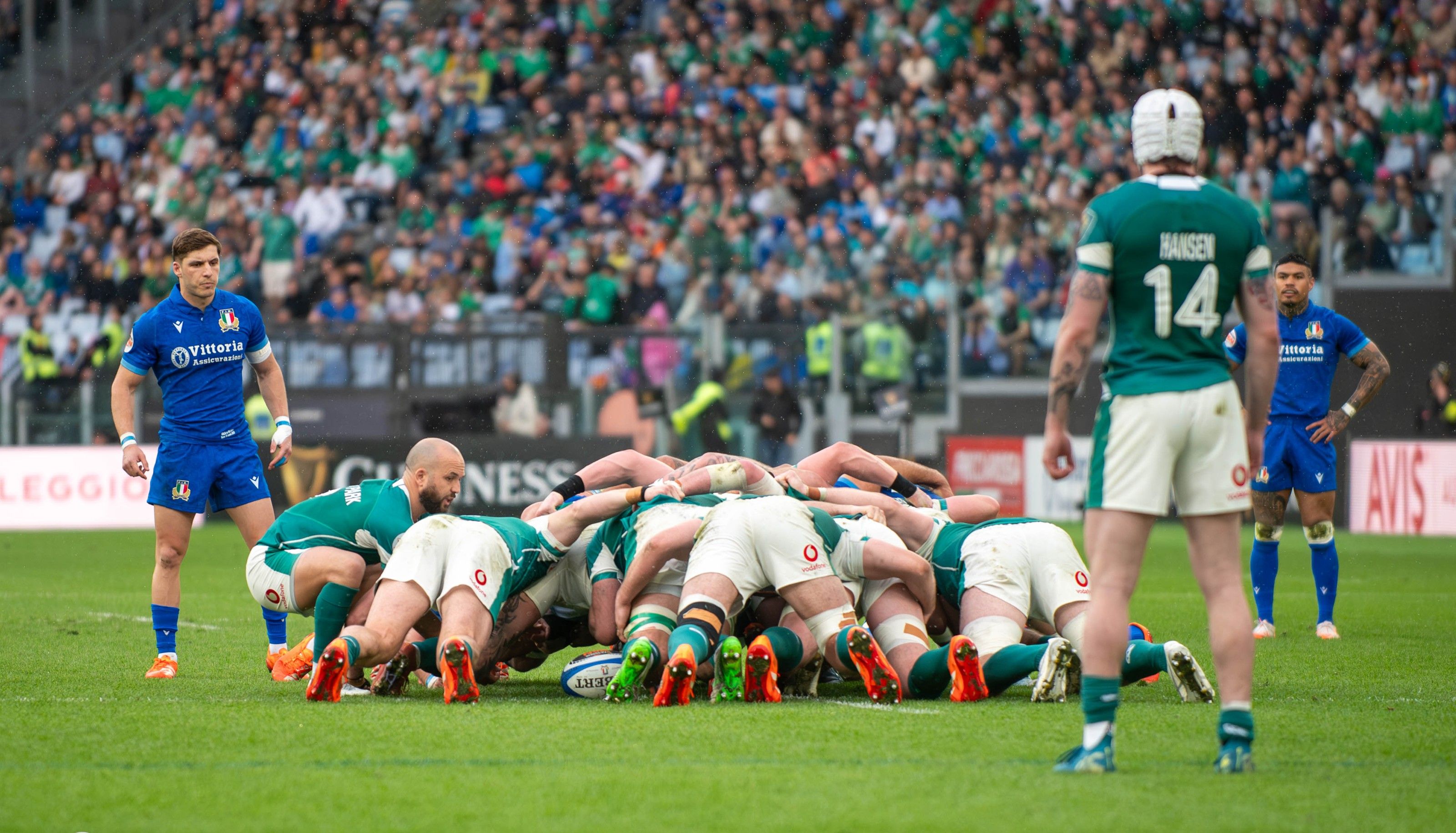 Italy and Ireland forwards bound together in a scrum at the Stadio Olimpico in Rome, with the crowd behind