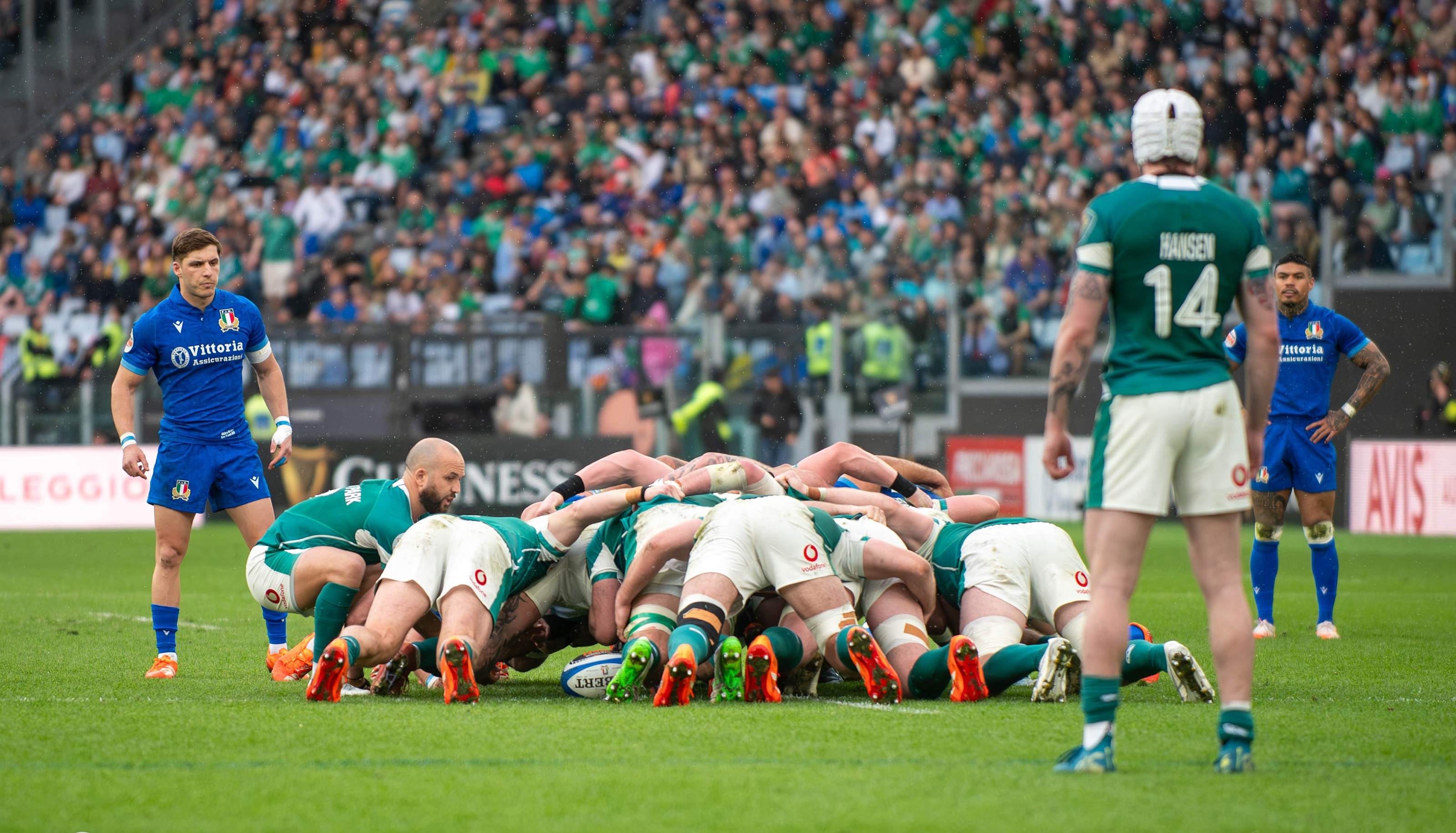 Italy and Ireland forwards bound together in a scrum at the Stadio Olimpico in Rome, with the crowd behind