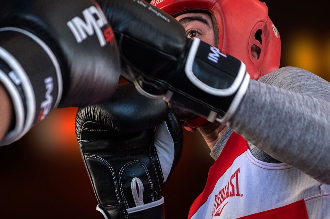 Professional boxing match action with a dominant fighter pressing forward