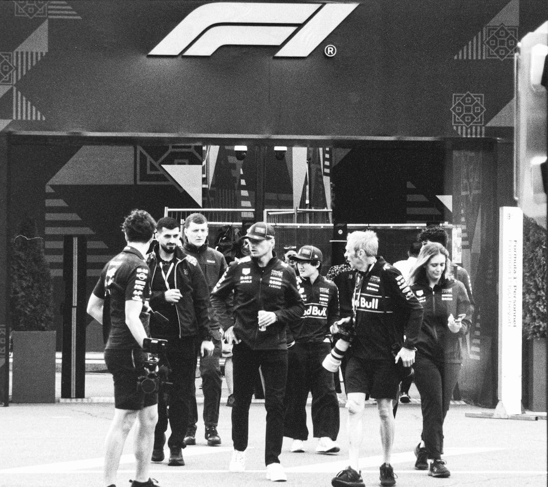 Formula 1 team members in the paddock, representing the sport's evolving safety standards