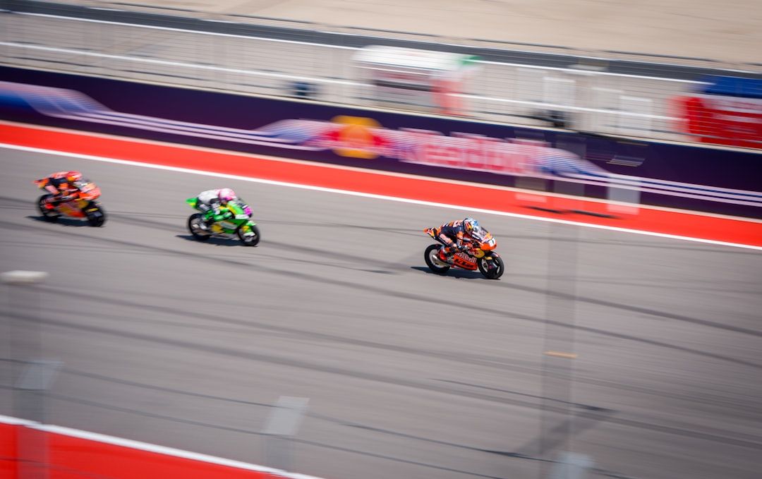 Motorcycles racing on track with blurred motion conveying speed