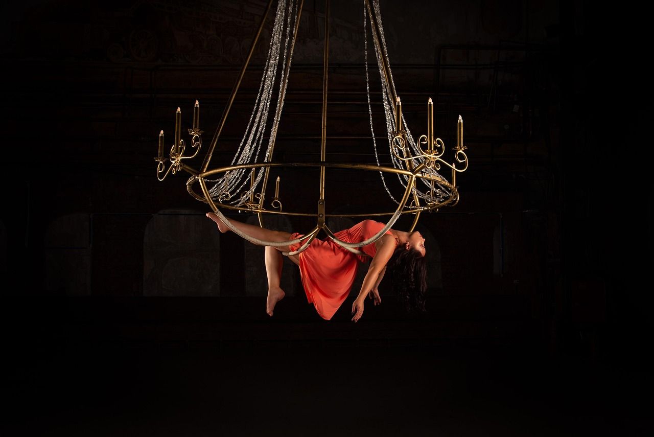 An aerial silks performer in a contemporary circus setting, evoking the artistry of Cirque du Soleil's O