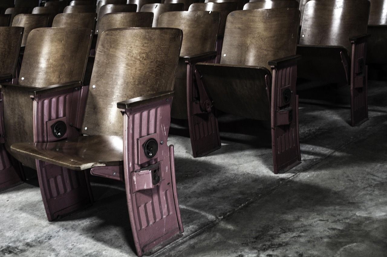 Theatre auditorium with red velvet seats, similar to the intimate off-Broadway venues where Avenue Q debuted