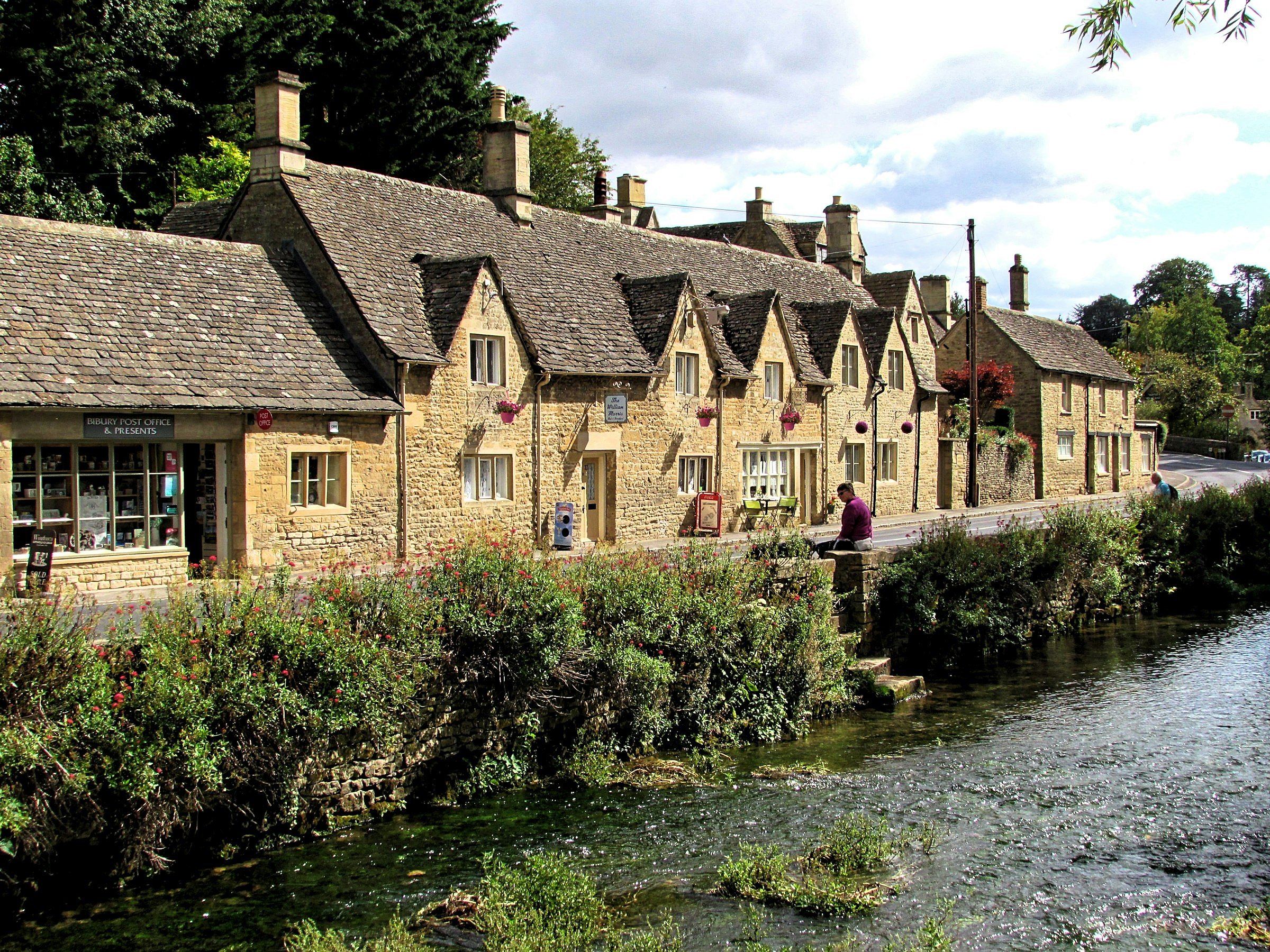 Cheltenham and the Cotswolds (brown concrete houses beside river)