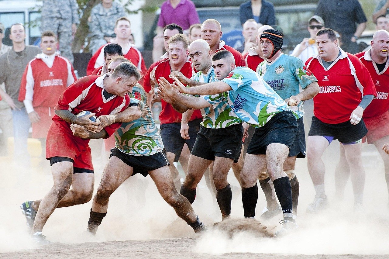 Rugby union players competing in a tackle, evoking the physicality of the earliest international matches