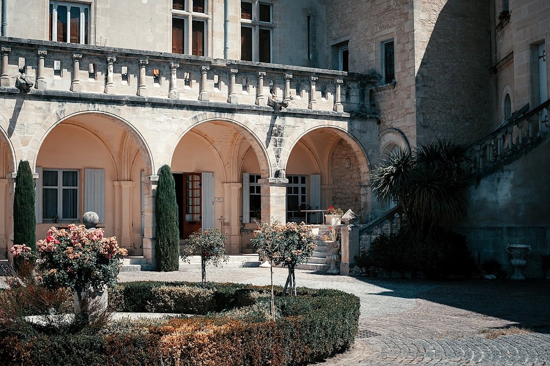 A grand Bordeaux château surrounded by manicured vineyard gardens
