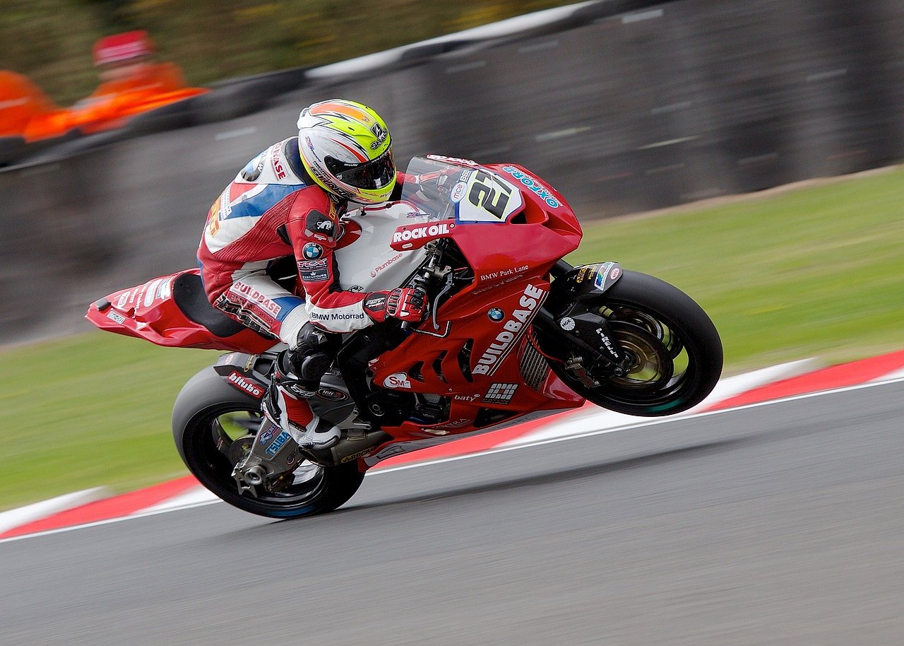 Motorcycle racer leaning into a corner on a racing circuit