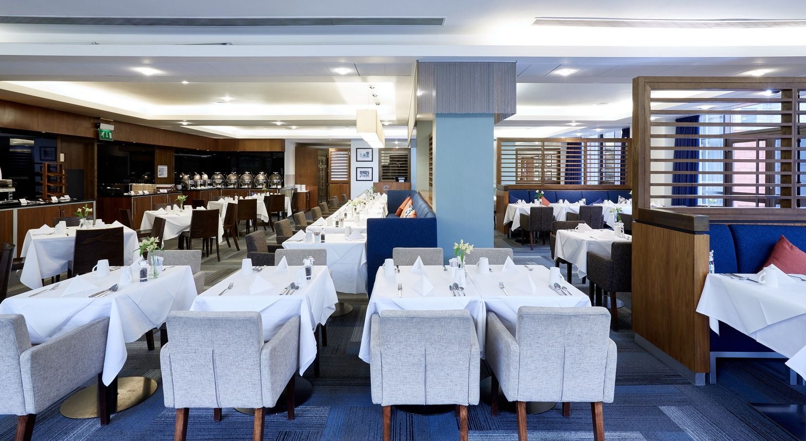Tables set with white linen in the Blues dining room at the Copthorne, Stamford Bridge