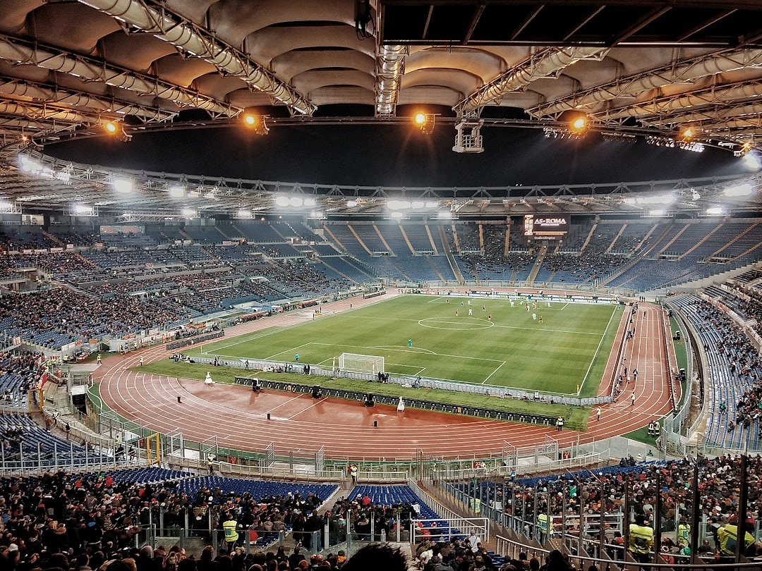 Football stadium illuminated at night during a European Championship match