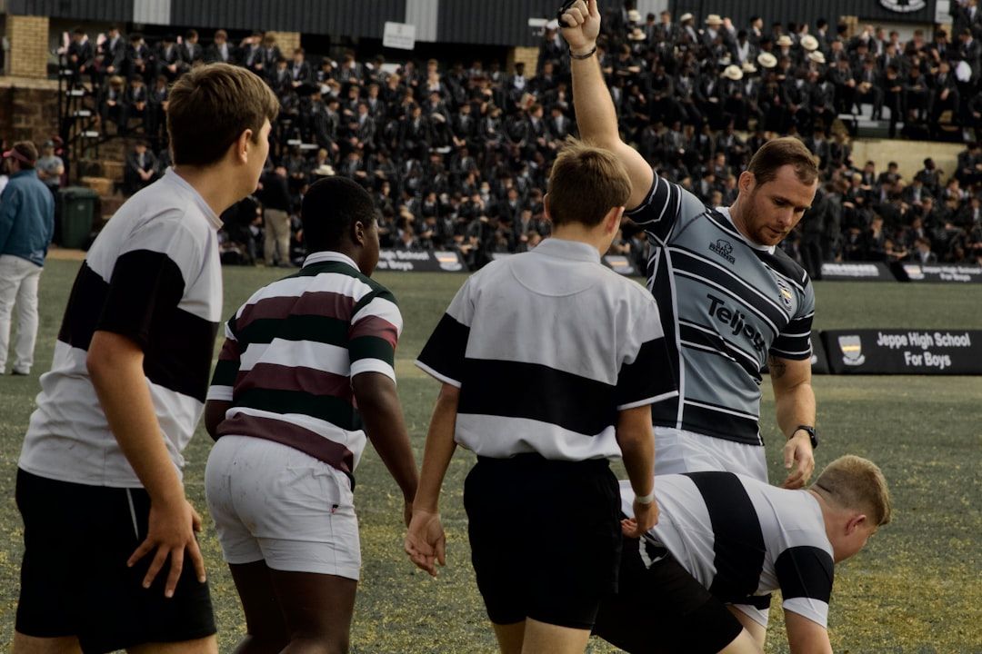 Rugby sevens team celebrating together on the pitch