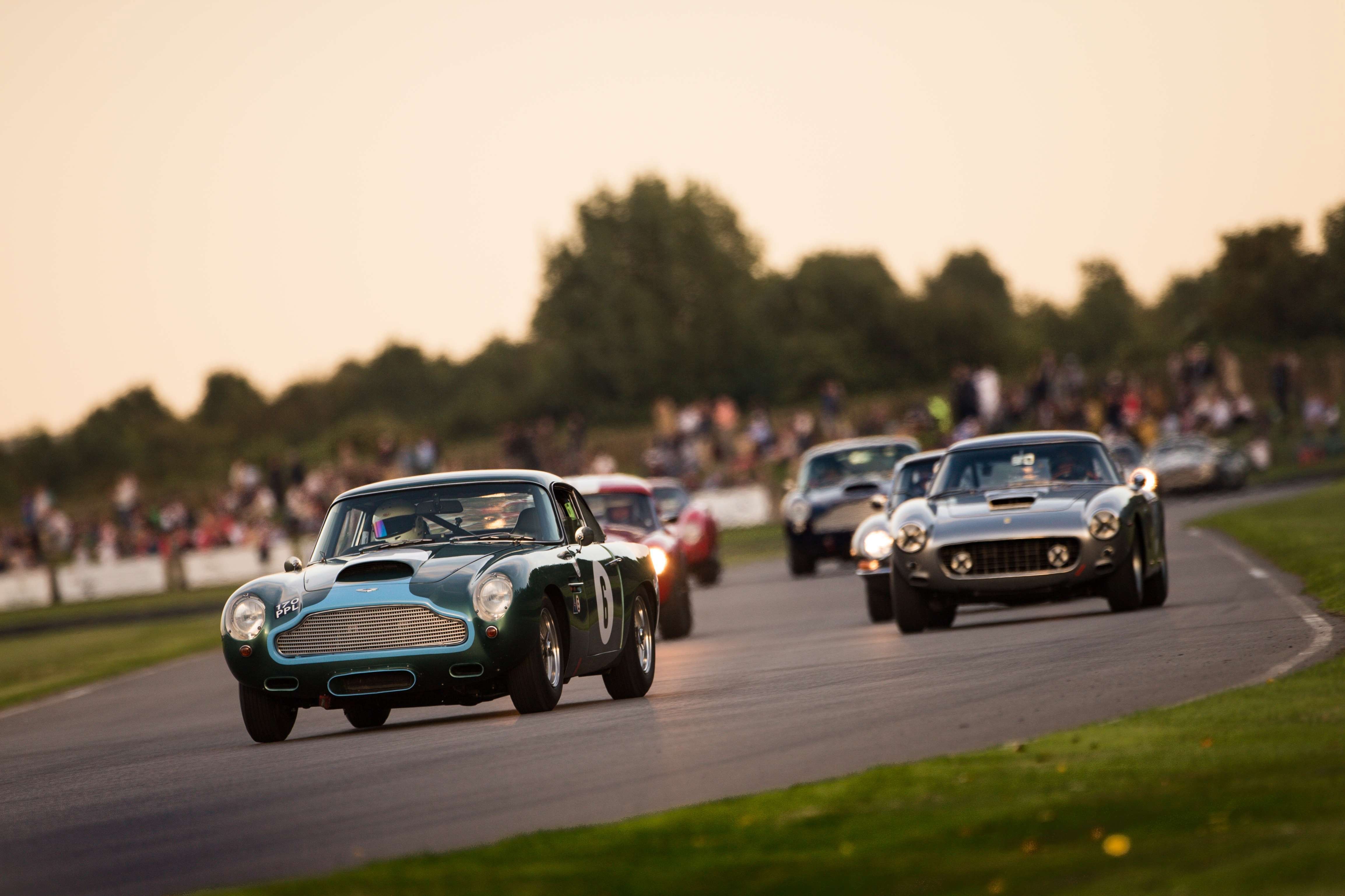 Period sports cars racing wheel to wheel at the Goodwood Revival