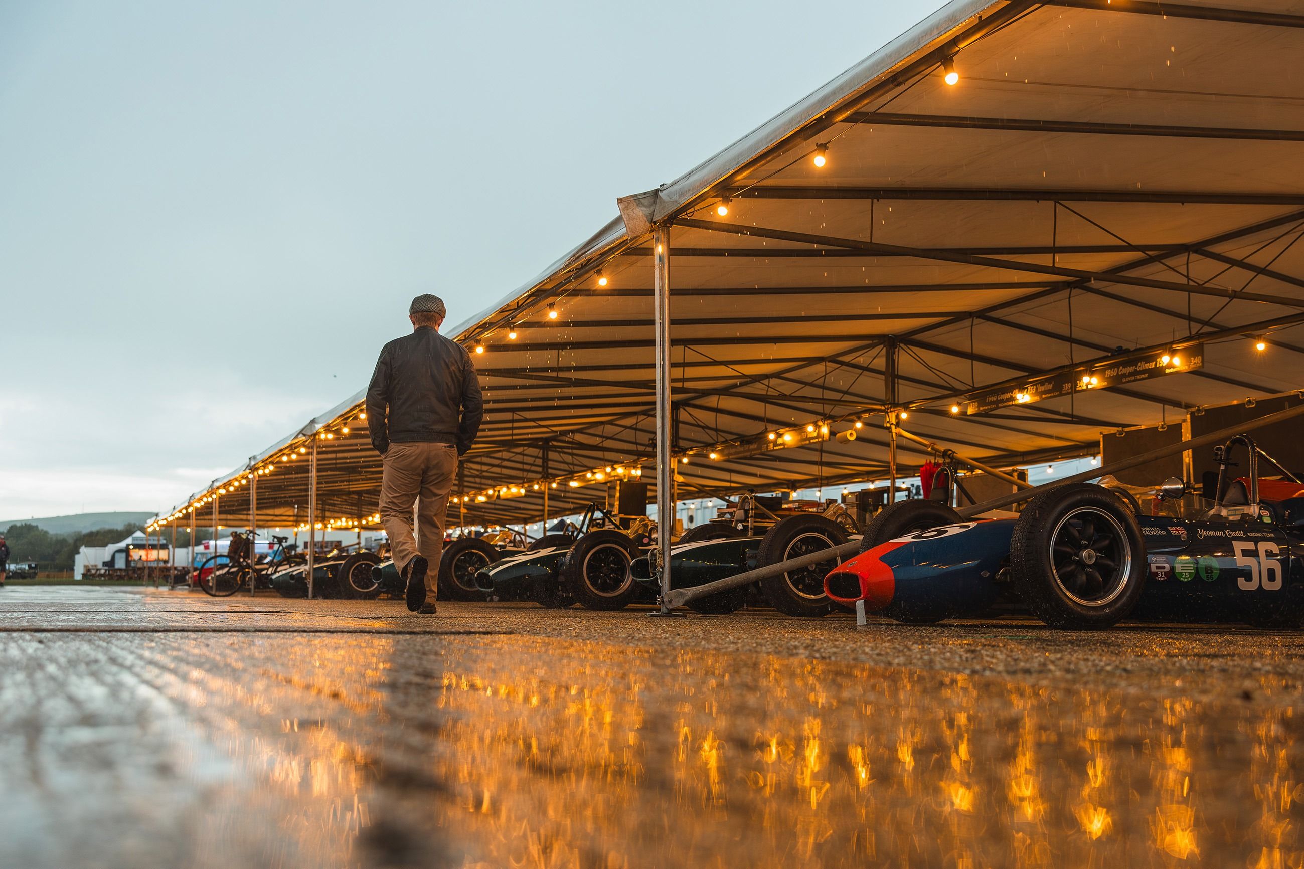 A Brabham Formula 1 car running before the grandstand crowds during the Goodwood Revival's tribute to Sir Jack Brabham