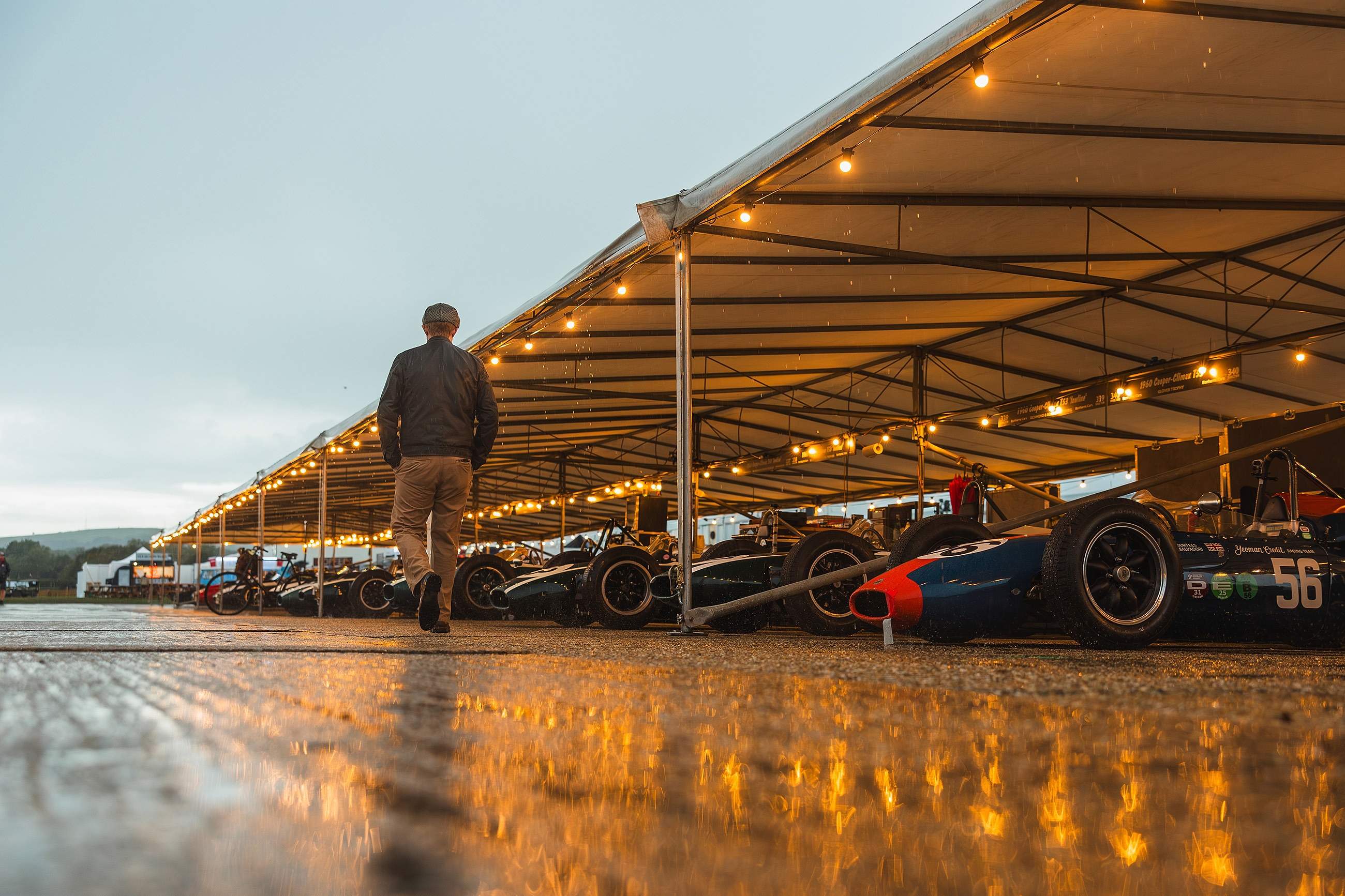 A Brabham Formula 1 car running before the grandstand crowds during the Goodwood Revival's tribute to Sir Jack Brabham