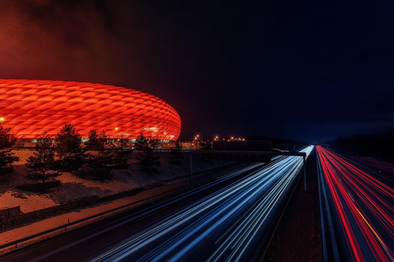 Football stadium under floodlights at night